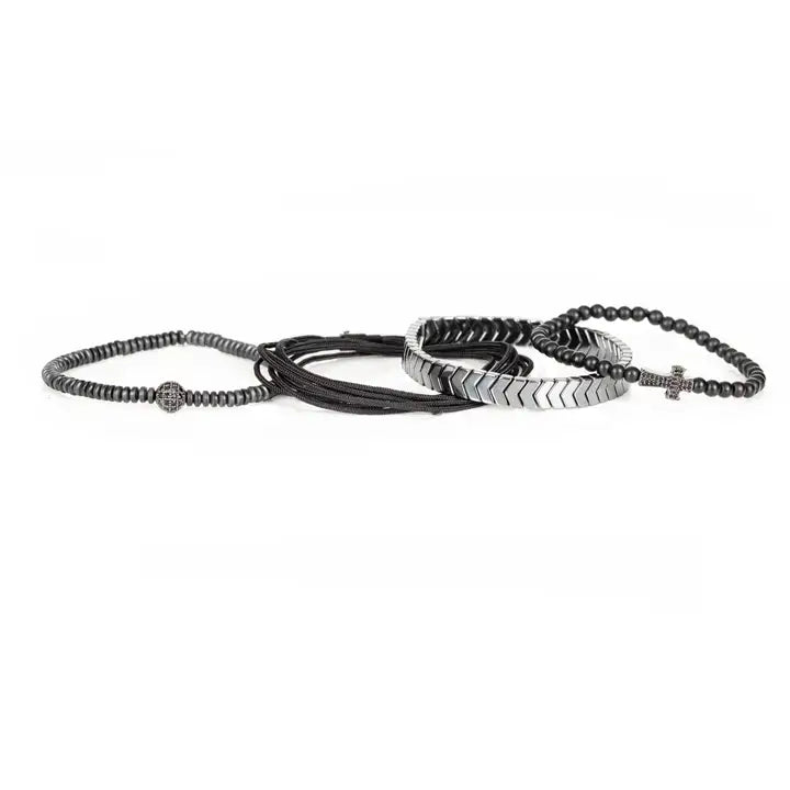 Black and silver layered men’s bracelet set with pavé cross detail, silver chevron metal strand, matte black beads, braided rope wraps, and pavé accent bead on white background.