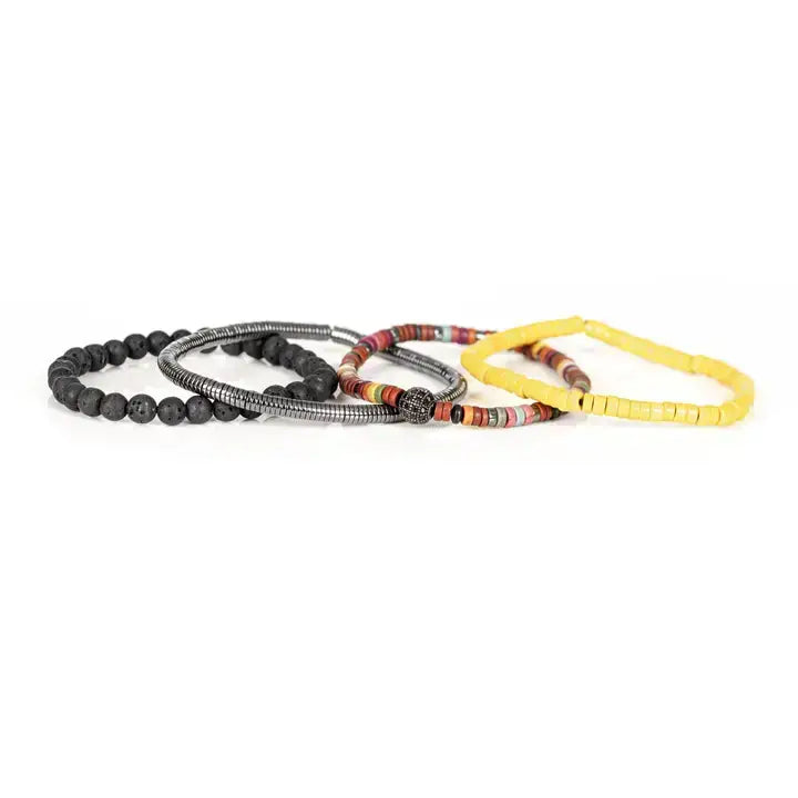 Men’s layered bracelet set featuring matte black lava stone beads, bright yellow heishi beads, multicolor tribal-inspired disc beads, a gunmetal pavé accent bead, and silver-tone coil wrap beads, stacked in a vibrant bohemian luxury design on a white background.
