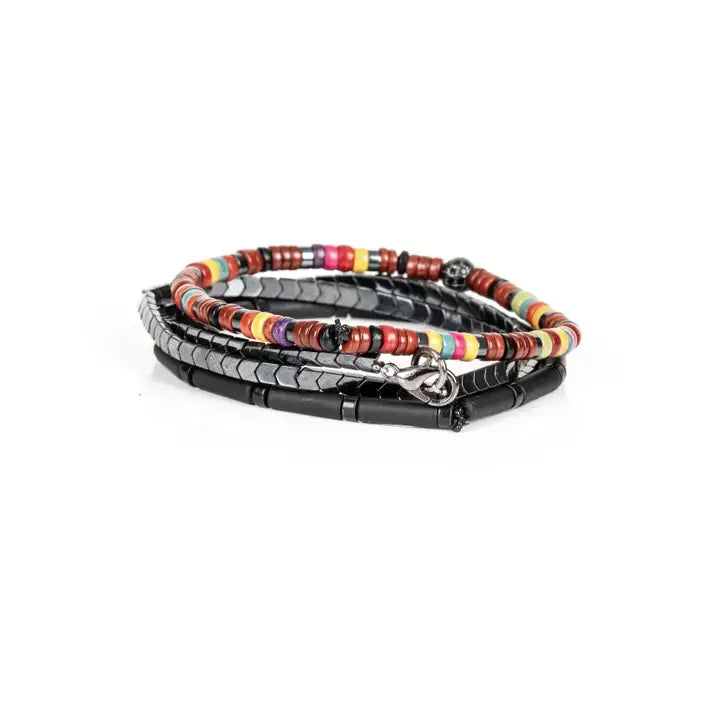 Multicolor multi-layer men’s bracelet featuring colorful disc beads, metallic hematite chevron strands, matte black tubular beads, and crystal centerpiece accent on a light background.