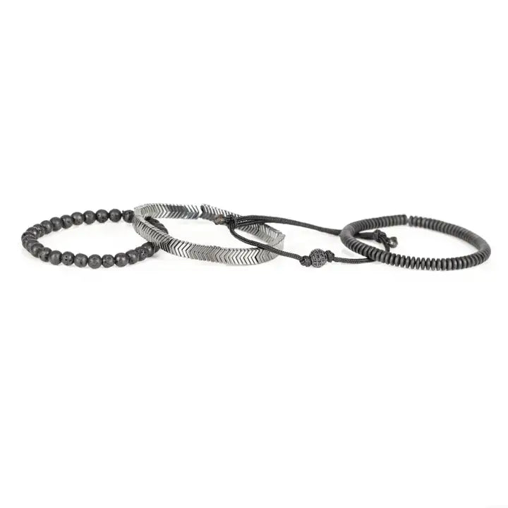 Black and silver layered men’s bracelet set with lava stone beads, silver chevron metal bar, matte black spacer beads, and pavé centerpiece on white background.