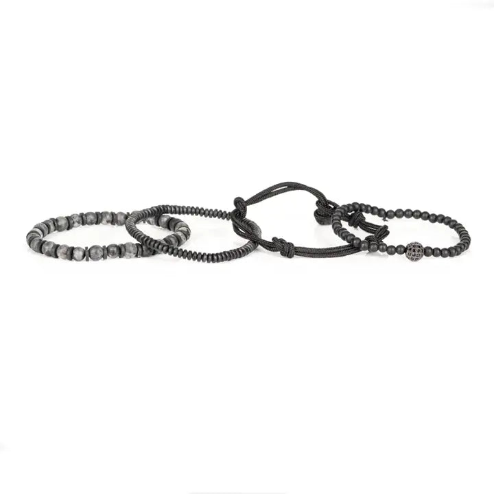 Black and gray layered men’s bracelet set with matte black beads, gray marbled stone accents, braided rope wraps, metallic spacers, and pavé centerpiece on white background.