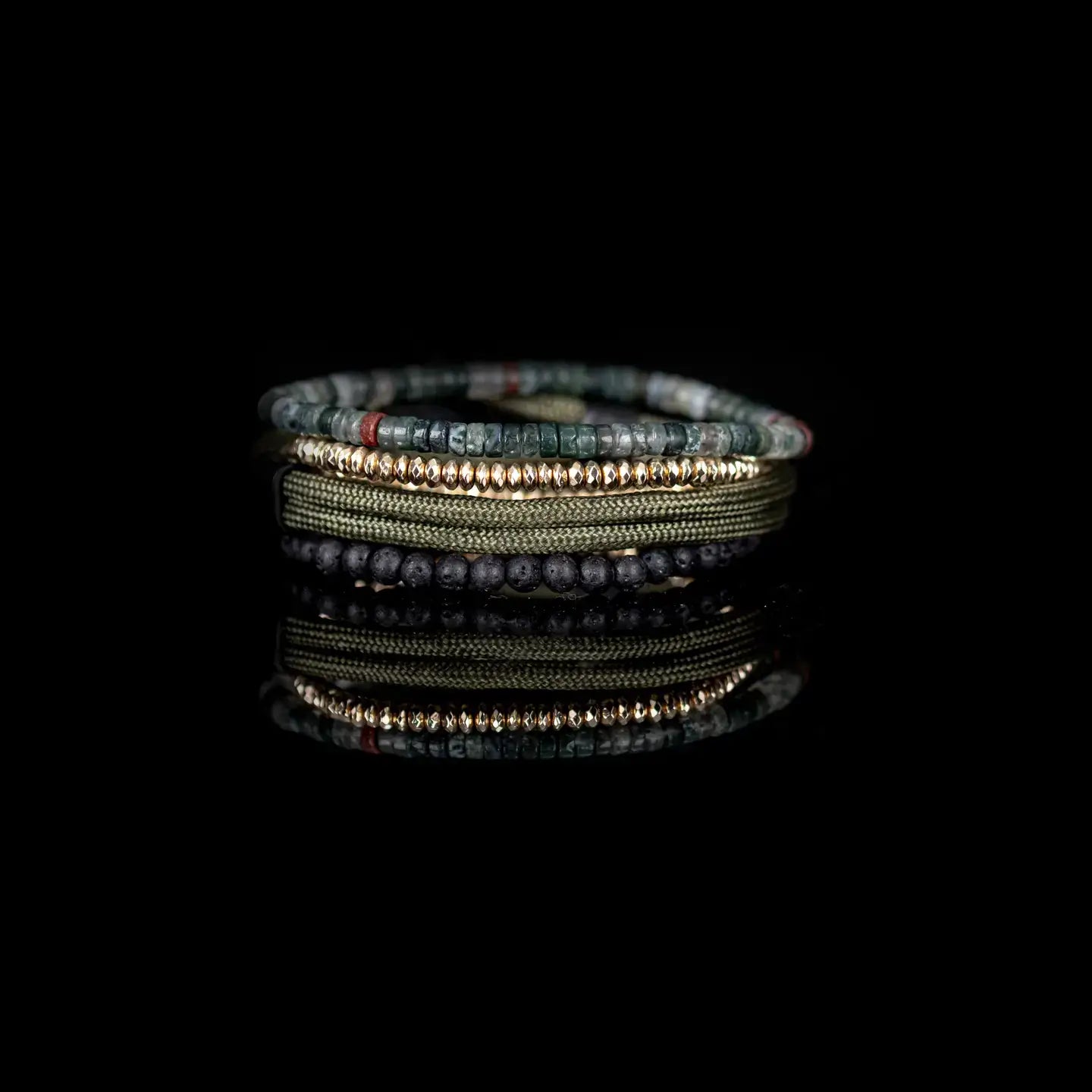 Green multi-layer men’s bracelet featuring natural stone disc beads, gold hematite spacers, olive braided rope layers, and lava stone bead strand on a light background.