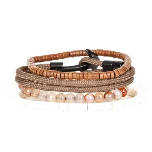 Men’s layered bracelet set featuring brown braided cord, brown heishi beads, polished black metal accents, warm-toned natural stone beads, and white heishi beads, stacked in a refined earthy luxury design on a white background.