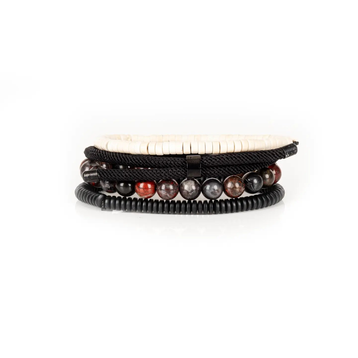 Men’s layered bracelet set featuring white howlite heishi beads, a gunmetal ID bar centerpiece, black braided cord wraps, red and black natural stone beads, and black coil wrap accents, stacked in a bold contemporary luxury design on a white background.