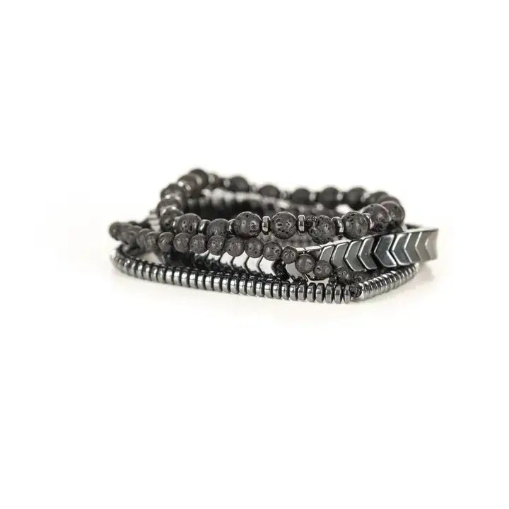 Black multi-layer men’s bracelet set featuring lava stone beads, silver chevron metal bar, hematite spacer beads, and layered metallic accents on a light background.