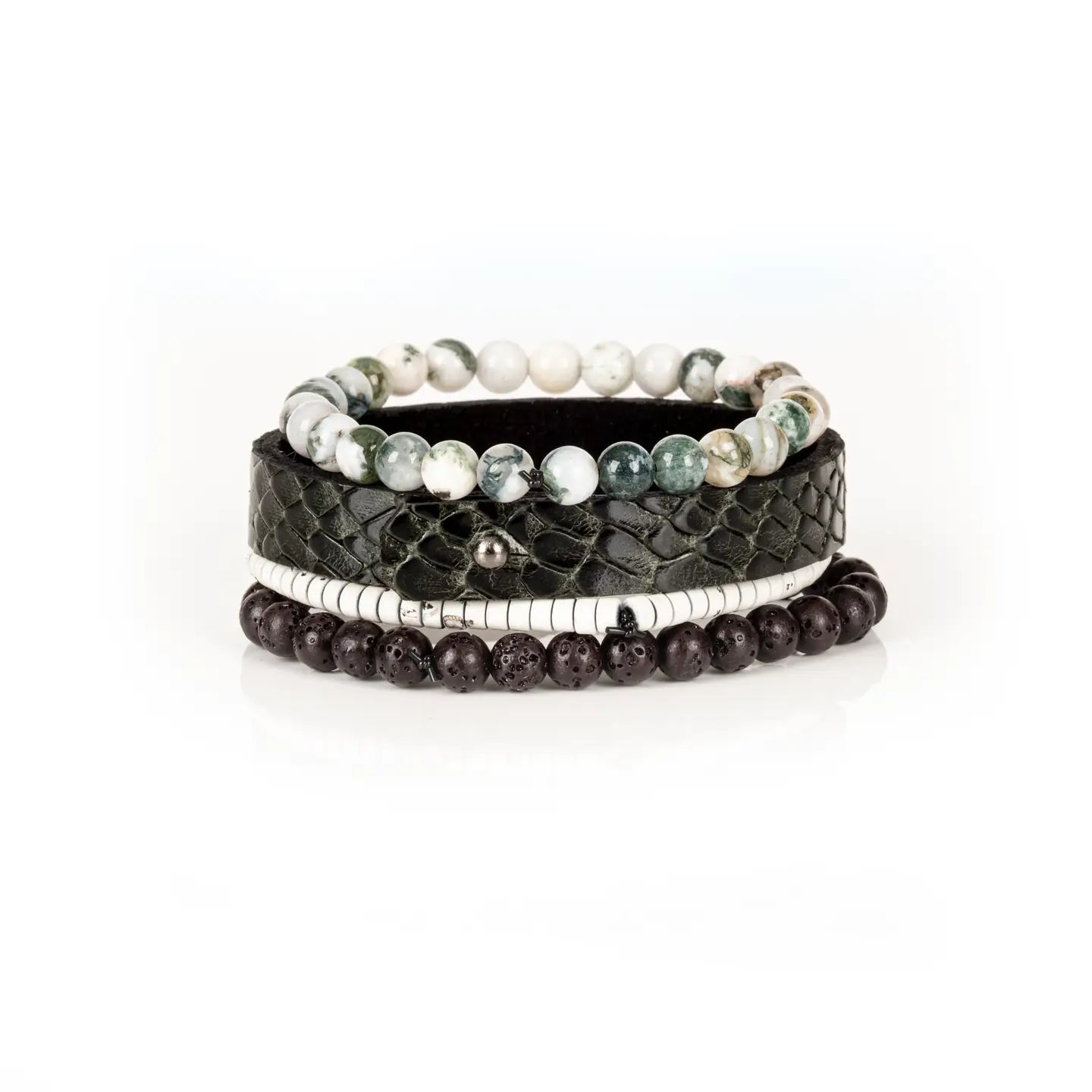 Men’s layered bracelet set featuring a black embossed leather cuff with a reptile-inspired texture, white howlite beads, green moss agate stone beads, white heishi beads, and dark lava stone beads, stacked in a sophisticated natural luxury design on a white background.