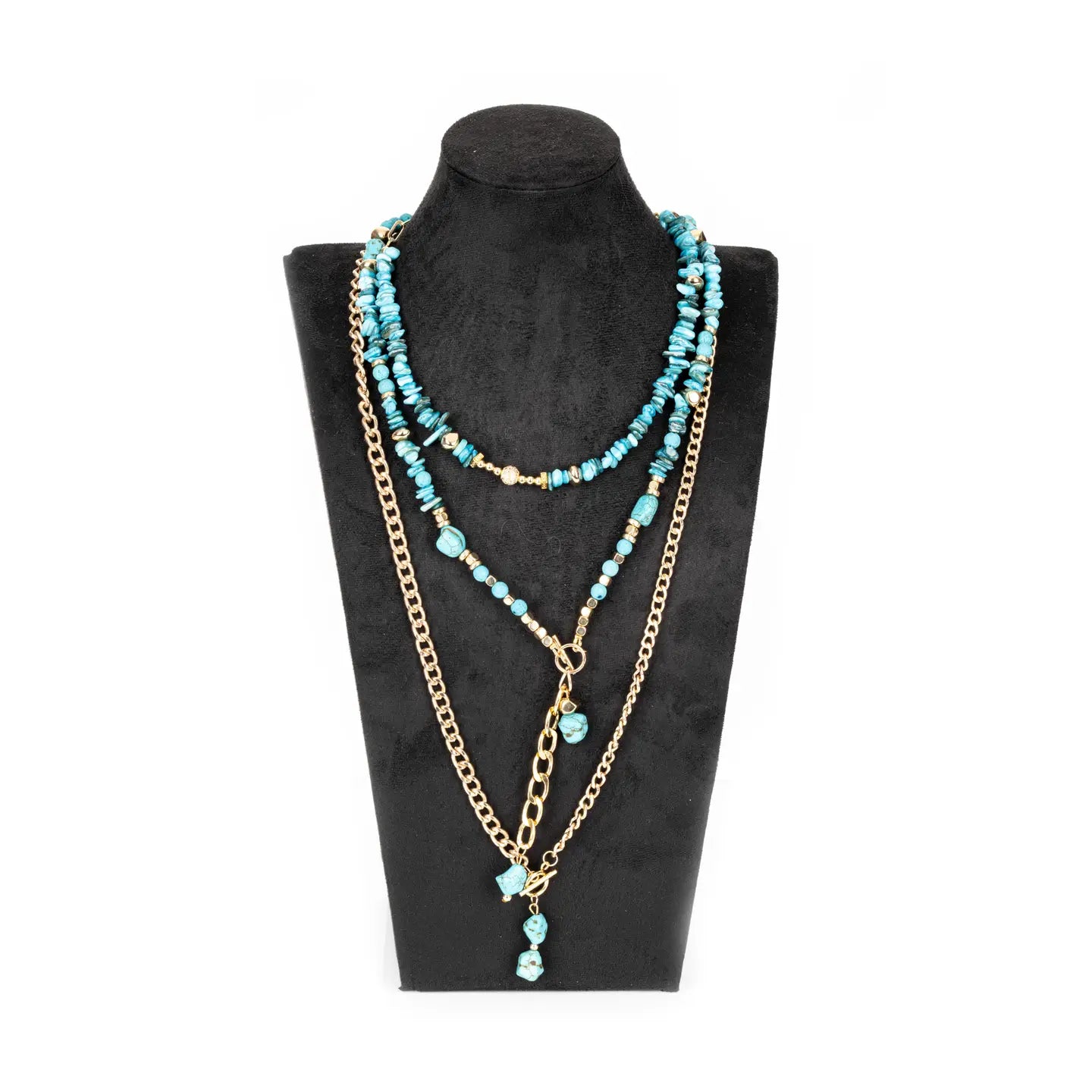 Layered turquoise beaded necklace with gold chain and drop pendant on white background.