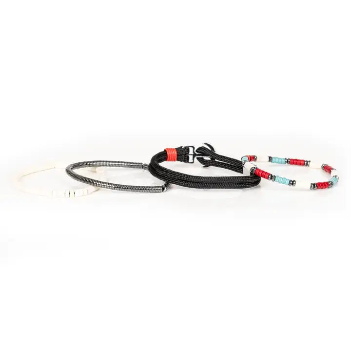 Men’s layered bracelet set featuring black braided cord, white heishi beads, turquoise and red disc beads, silver-tone accents, and hematite spacer beads, stacked in a contemporary bohemian luxury design on a white background.