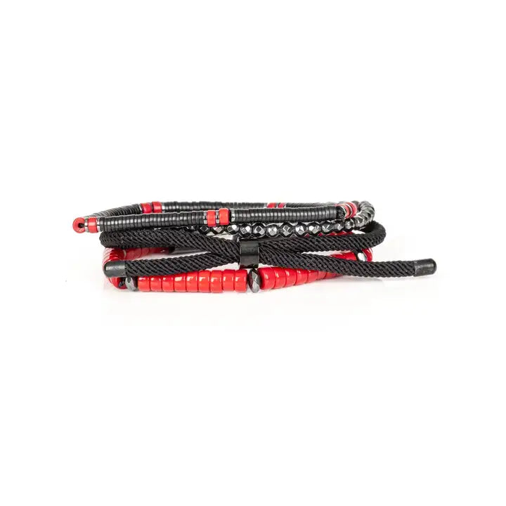 Men’s layered bracelet set featuring black and red heishi beads, faceted hematite crystal beads, black braided cord, a gunmetal ID bar centerpiece, and black accent beads, stacked in a bold contemporary luxury design on a white background.