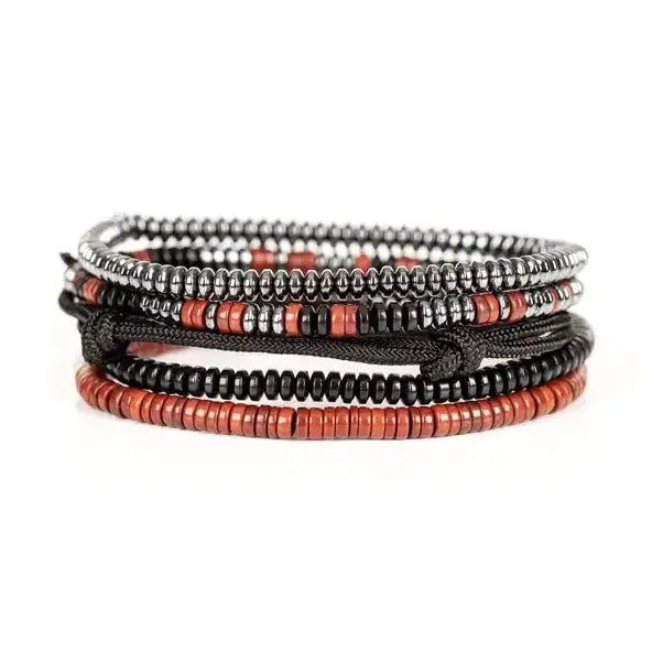 Men's layered bracelet set featuring silver-tone hematite spacer beads, coral red heishi beads, black accent beads, and black adjustable cord details arranged in a handcrafted stacked design on a white background.
