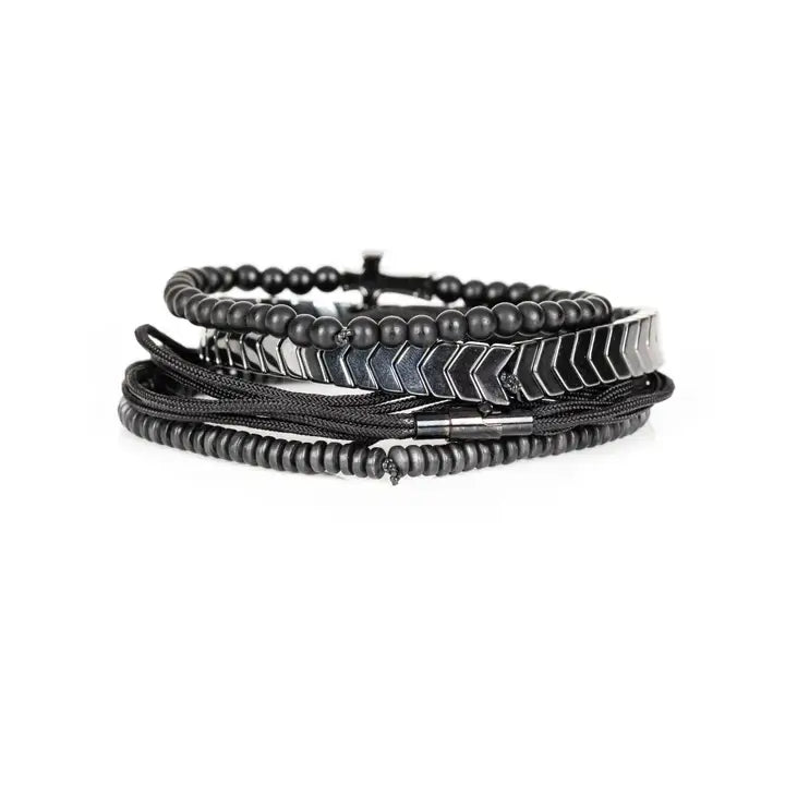 Black and silver layered men’s bracelet set with pavé cross detail, silver chevron metal strand, matte black beads, braided rope wraps, and pavé accent bead on white background.
