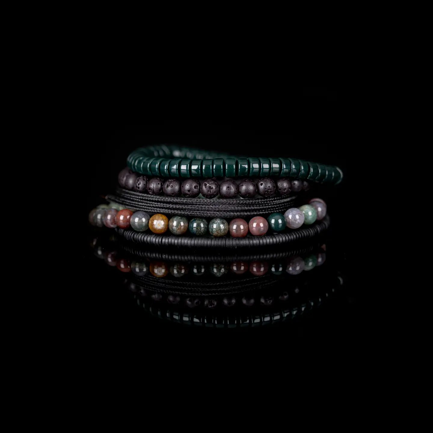 Handmade men's bracelet stack featuring natural lava stone beads, green heishi beads, multicolor gemstone beads, and black accents.