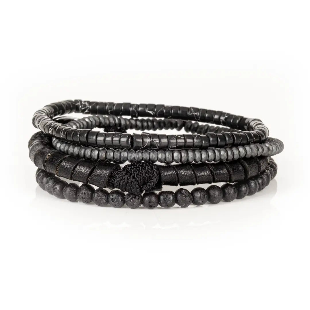 Men’s layered bracelet set featuring matte black lava stone beads, black leather-wrapped cord, black marbled heishi beads, faceted gray crystal beads, and dark metallic spacer beads, stacked in a sleek monochromatic luxury design on a white background.