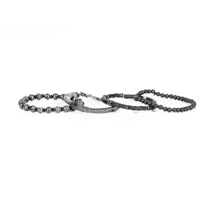 Black and silver multi-layer men’s bracelet featuring lava stone beads, hematite disc strands, silver chevron metal detail, pyramid-cut metallic accents, and marble grey natural stone beads on a light background.