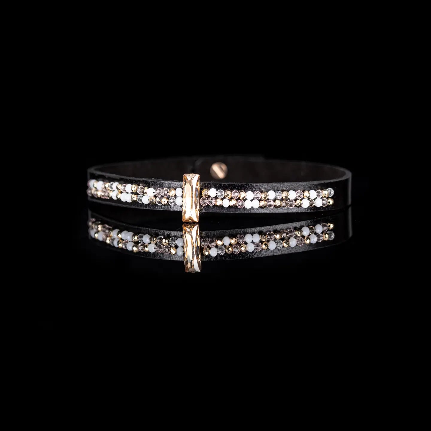 Black leather choker with a central champagne crystal and mixed white and gold crystal detailing along the band, displayed on a white background.