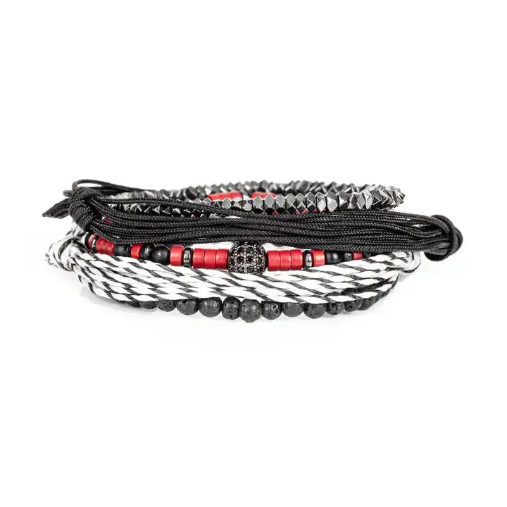 Black and red layered men’s bracelet set with lava stone beads, braided rope wraps, metallic accents, and pavé centerpiece on white background.