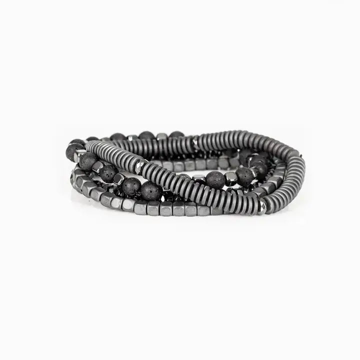 Men’s layered bracelet set featuring silver-tone coil wrap beads, matte black lava stone beads, polished hematite cube beads, faceted hematite crystal beads, and metallic spacer accents, stacked in a sleek industrial luxury design on a white background.
