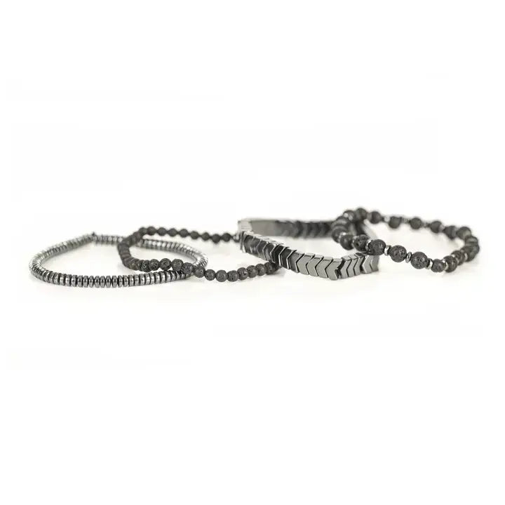 Black multi-layer men’s bracelet featuring lava stone beads, silver chevron metal bar, hematite spacer beads, and layered metallic accents on a light background.
