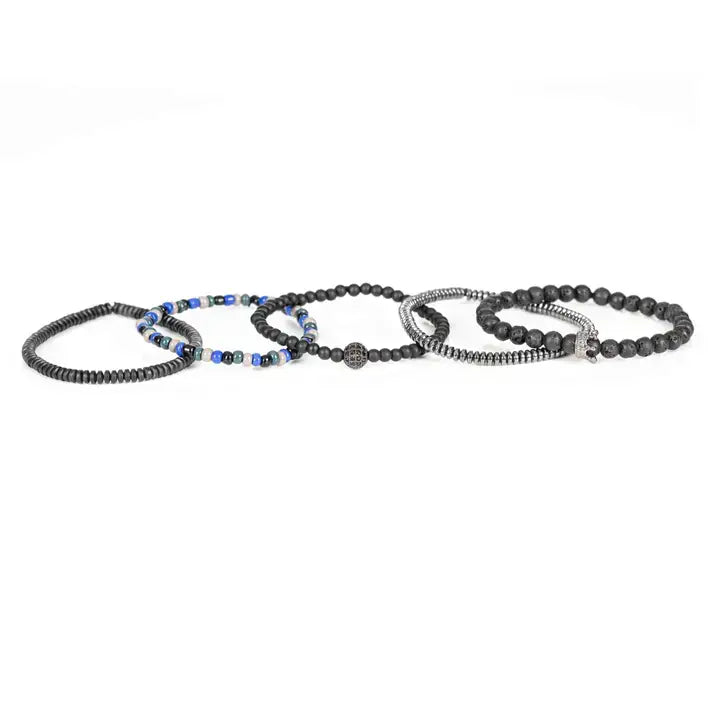 Black multi-layer men’s bracelet featuring lava stone beads, metallic hematite strands, crystal crown centerpiece, blue and white accent beads, and layered black bead details on a light background.