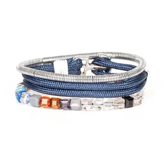 Men’s layered bracelet set featuring blue braided cord, silver-tone coil wrap, faceted crystal cube beads in blue, orange, gray, black, and clear tones, finished with polished metal accents in a modern luxury style on a white background.