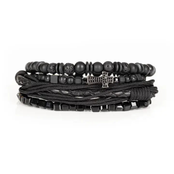 Black layered men’s bracelet set with lava stone beads, braided leather, rope wraps, faceted crystal accents, and pavé cross detail on white background