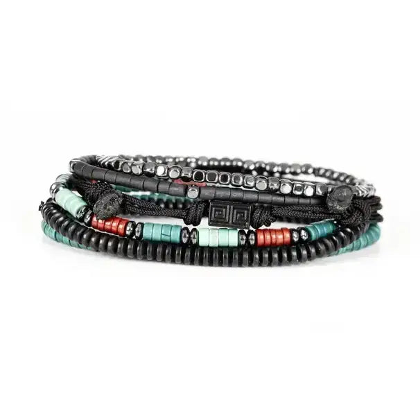 Black multi-layer men’s bracelet featuring hematite bead strands, braided rope layers, turquoise and red accent beads, geometric black centerpiece, and layered metallic details on a light background.