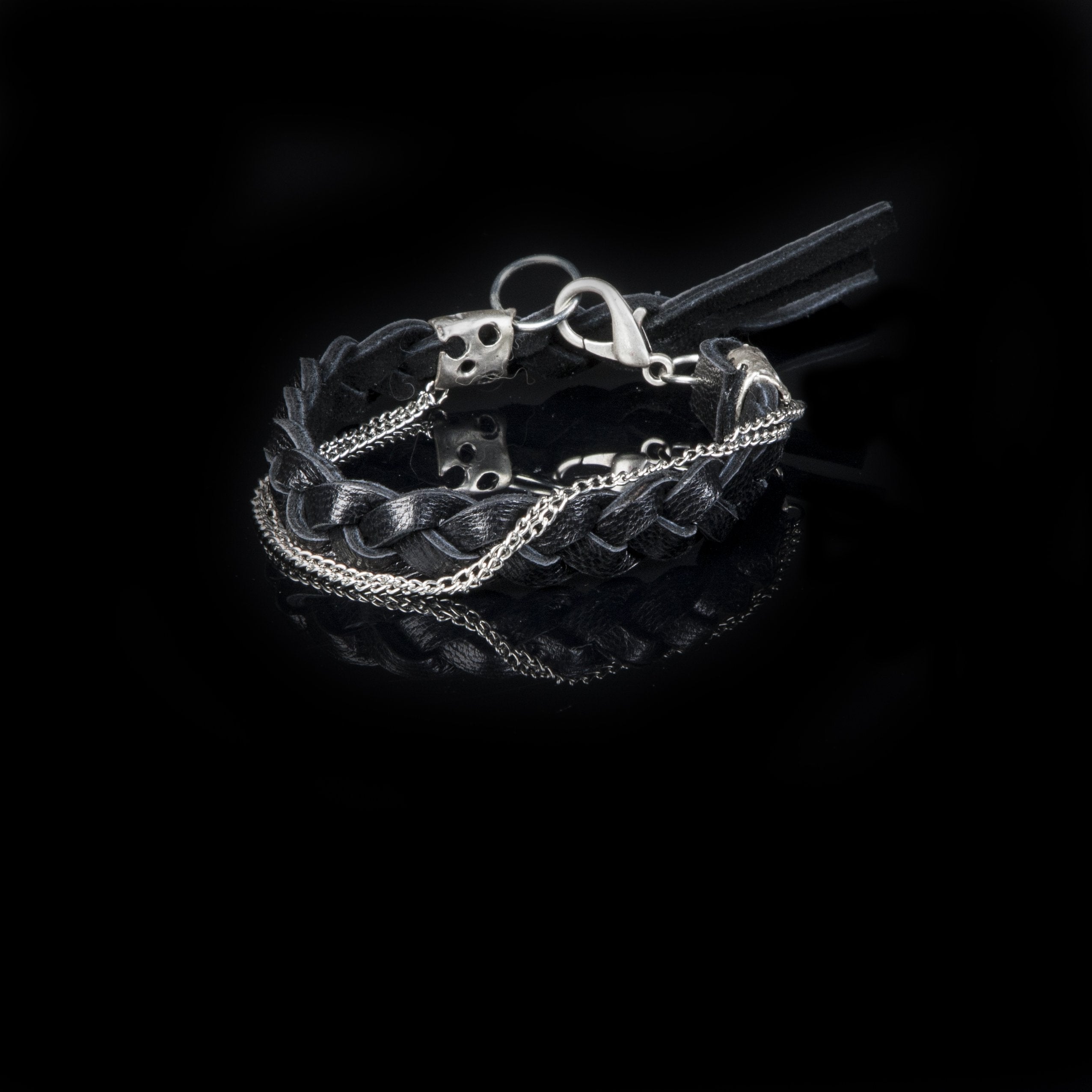 Handmade men's black braided leather bracelet featuring silver-tone chains, artisan metal accents, and leather tassel details.