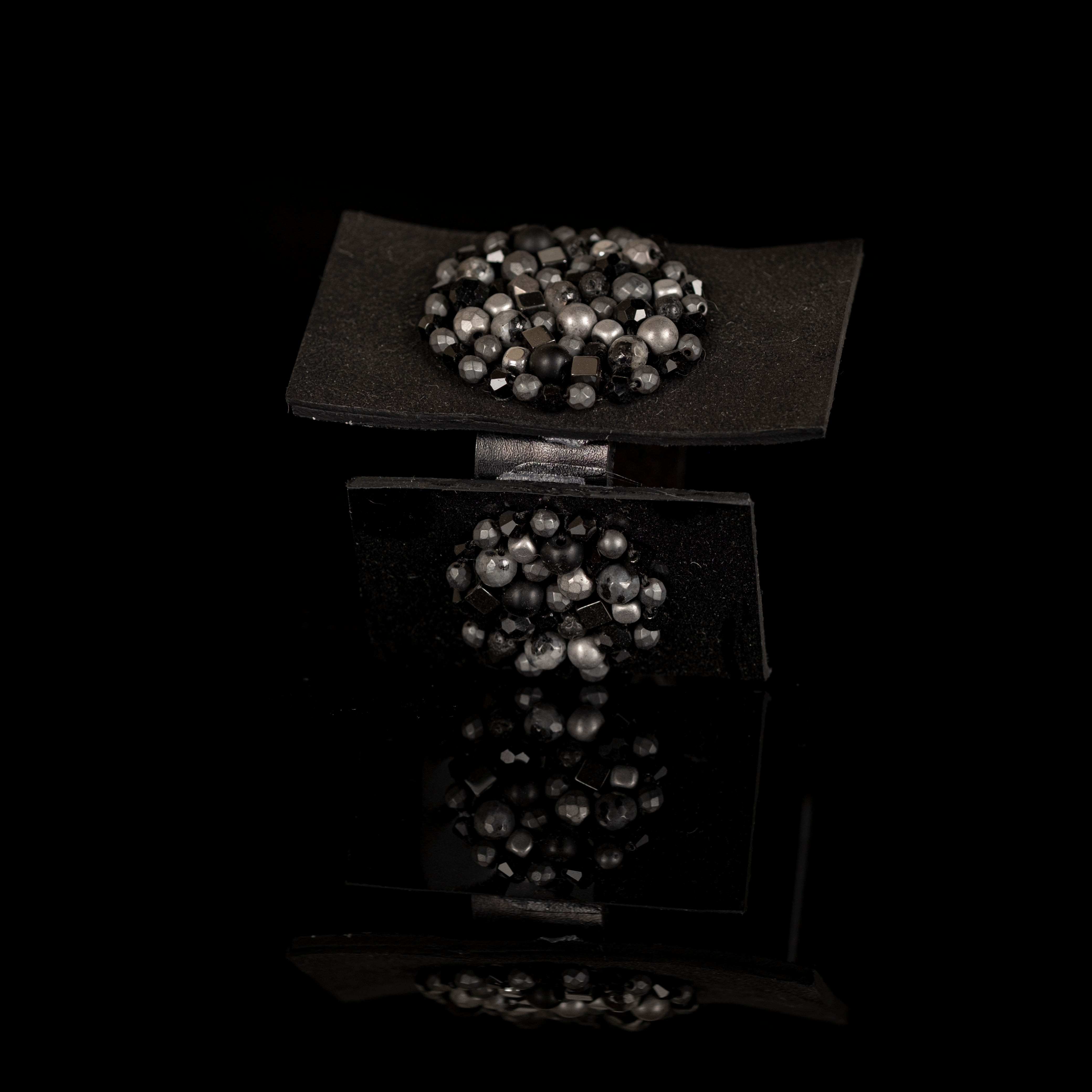 Black leather architectural cuff with circular bead clusters, handmade sculptural statement bracelet by THE DARK