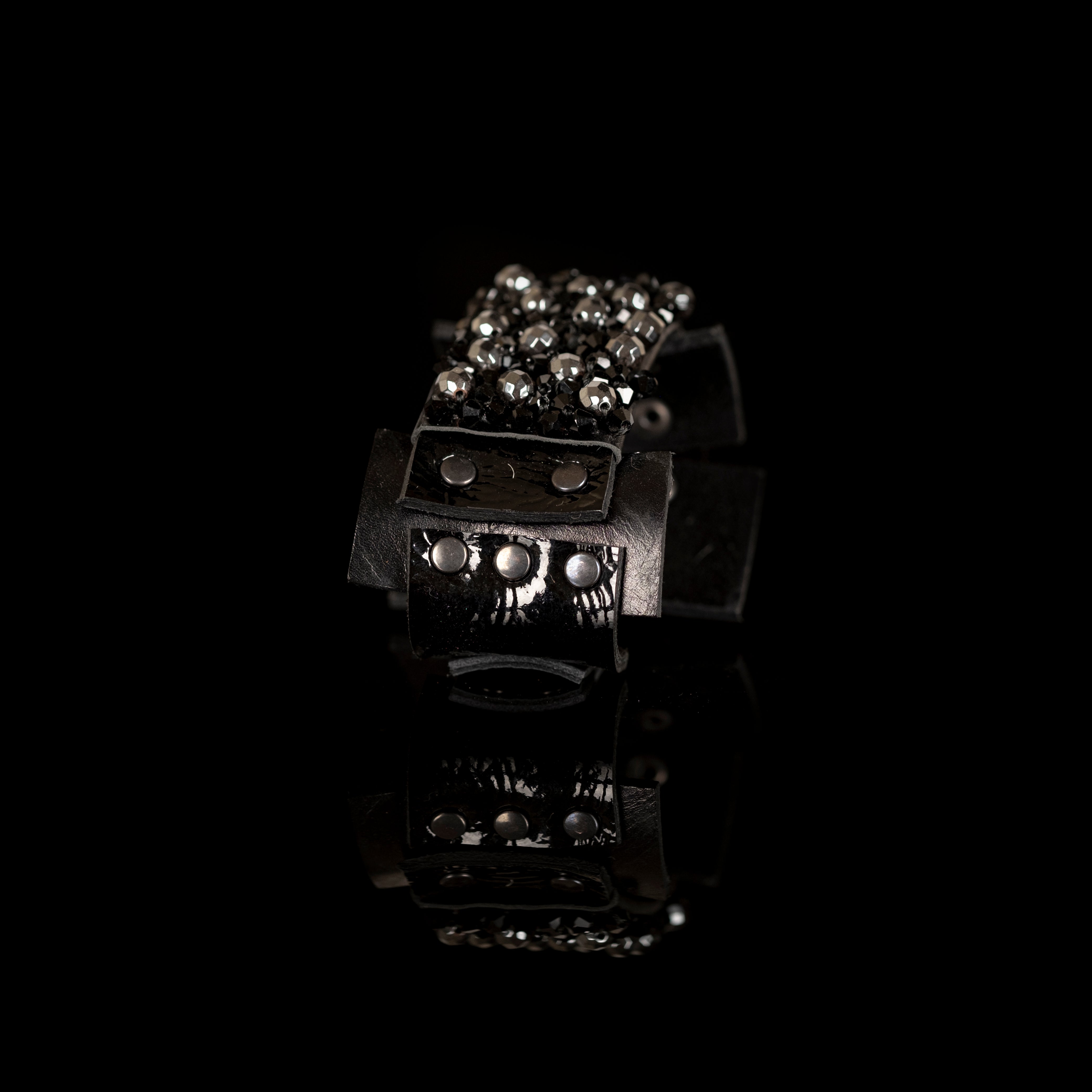 Black leather cuff bracelet with dense black crystal cluster and studded leather panels, handmade statement bracelet by THE DARK