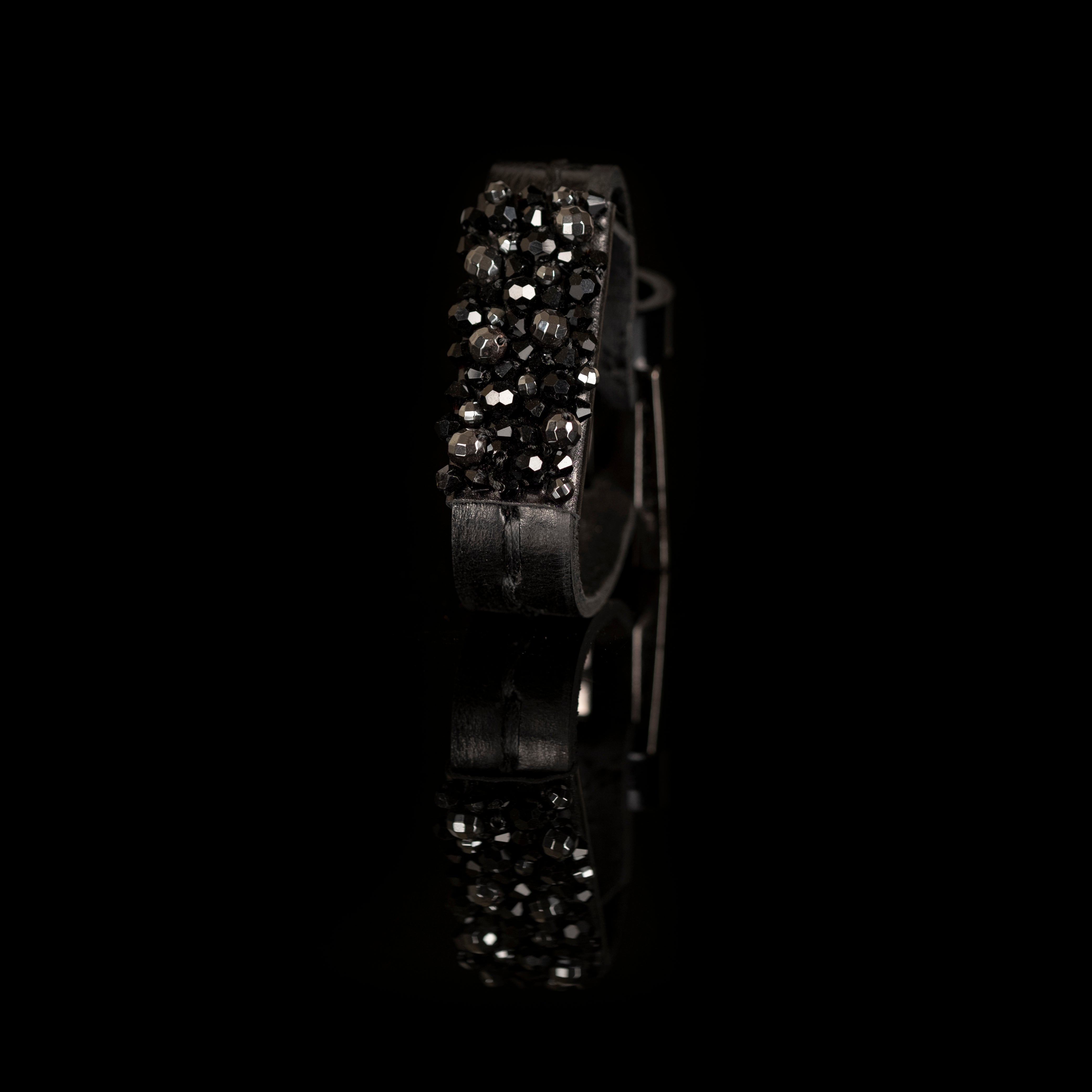 Black leather cuff bracelet with raised ridge of faceted black crystals, handmade statement bracelet by THE DARK