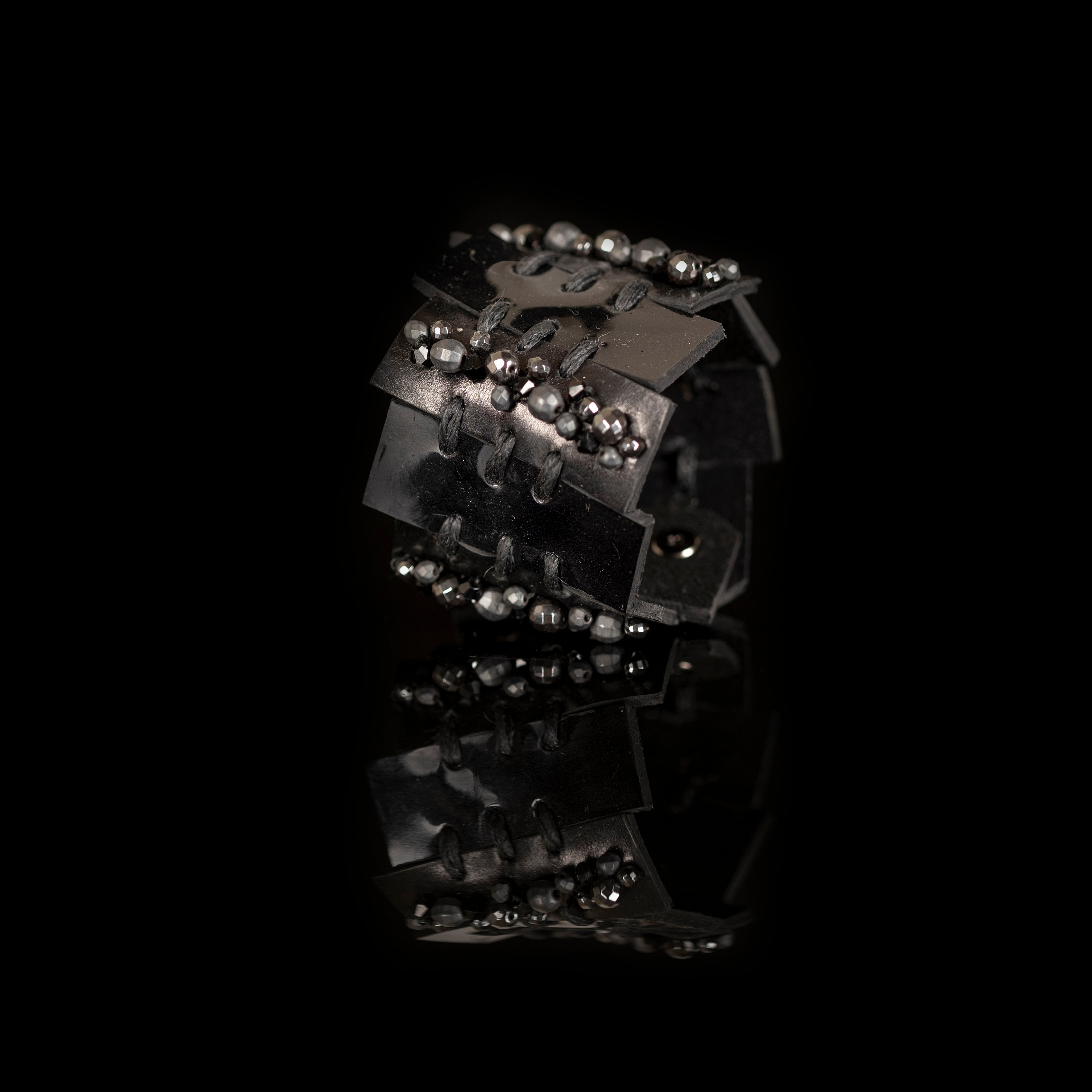 Black leather layered armor cuff bracelet with stitched panels and faceted metallic beads, handmade statement bracelet by THE DARK