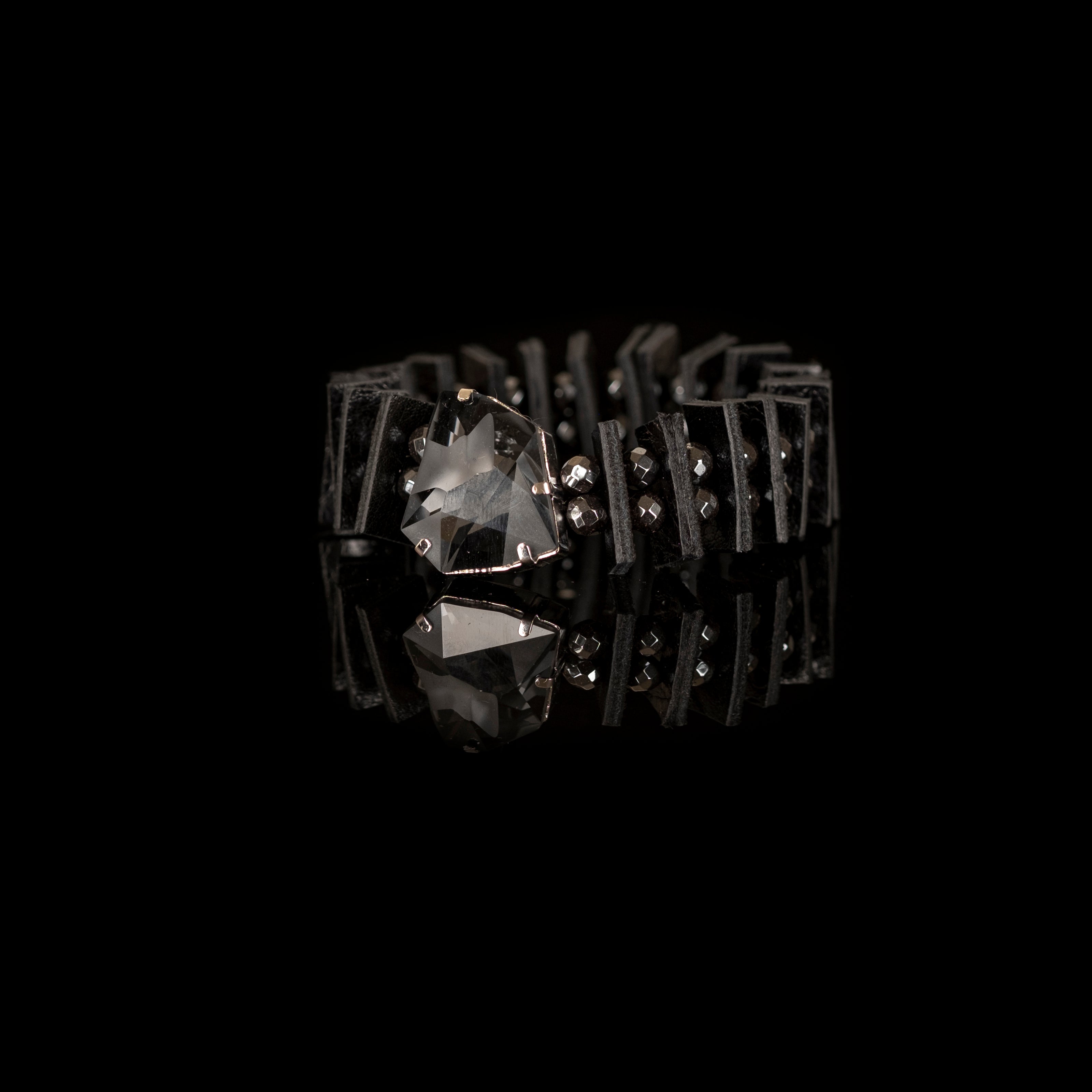Black geometric leather bracelet with large faceted crystal and layered leather segments, handmade statement bracelet by THE DARK