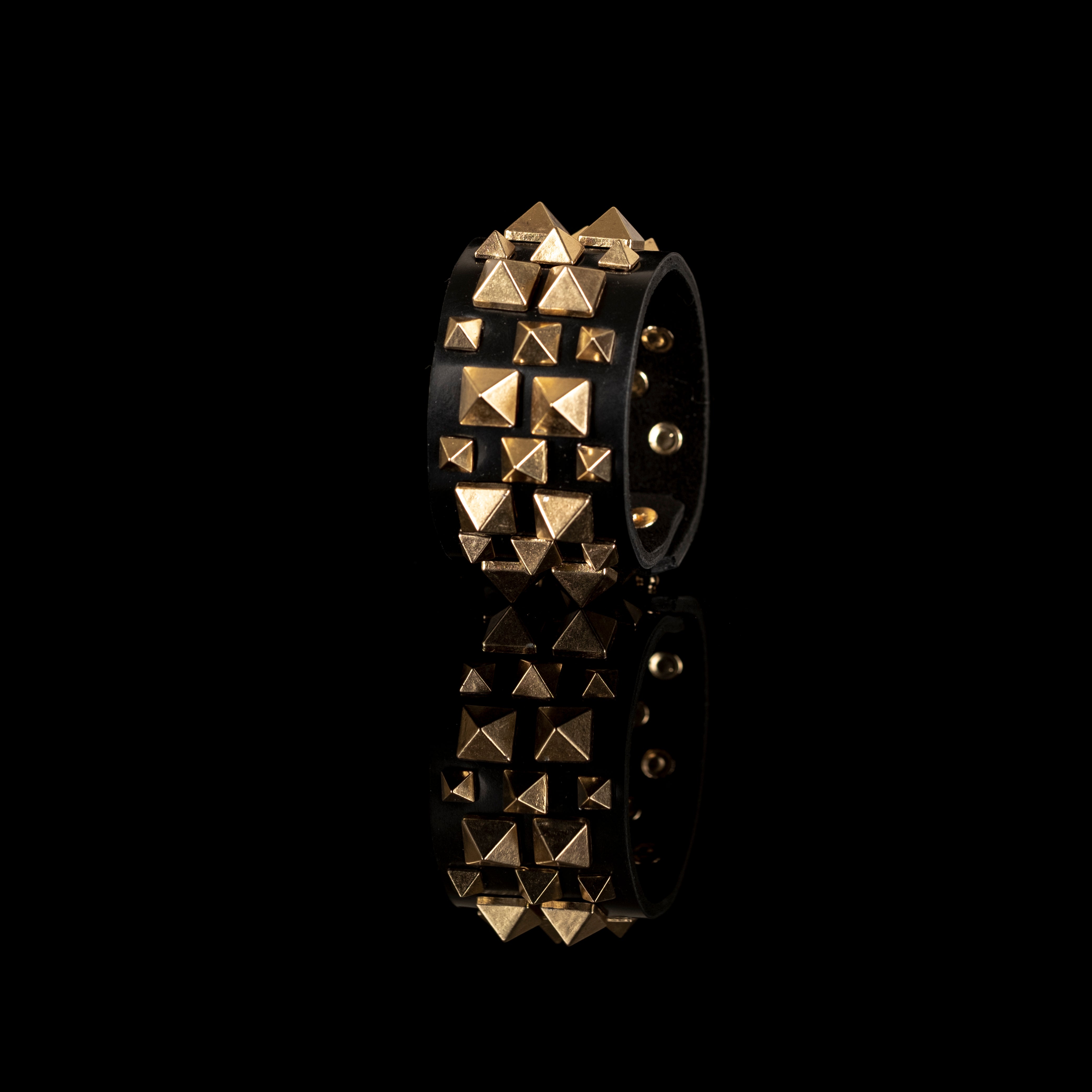 Black leather cuff bracelet with gold pyramid stud pattern, handmade statement bracelet by THE DARK