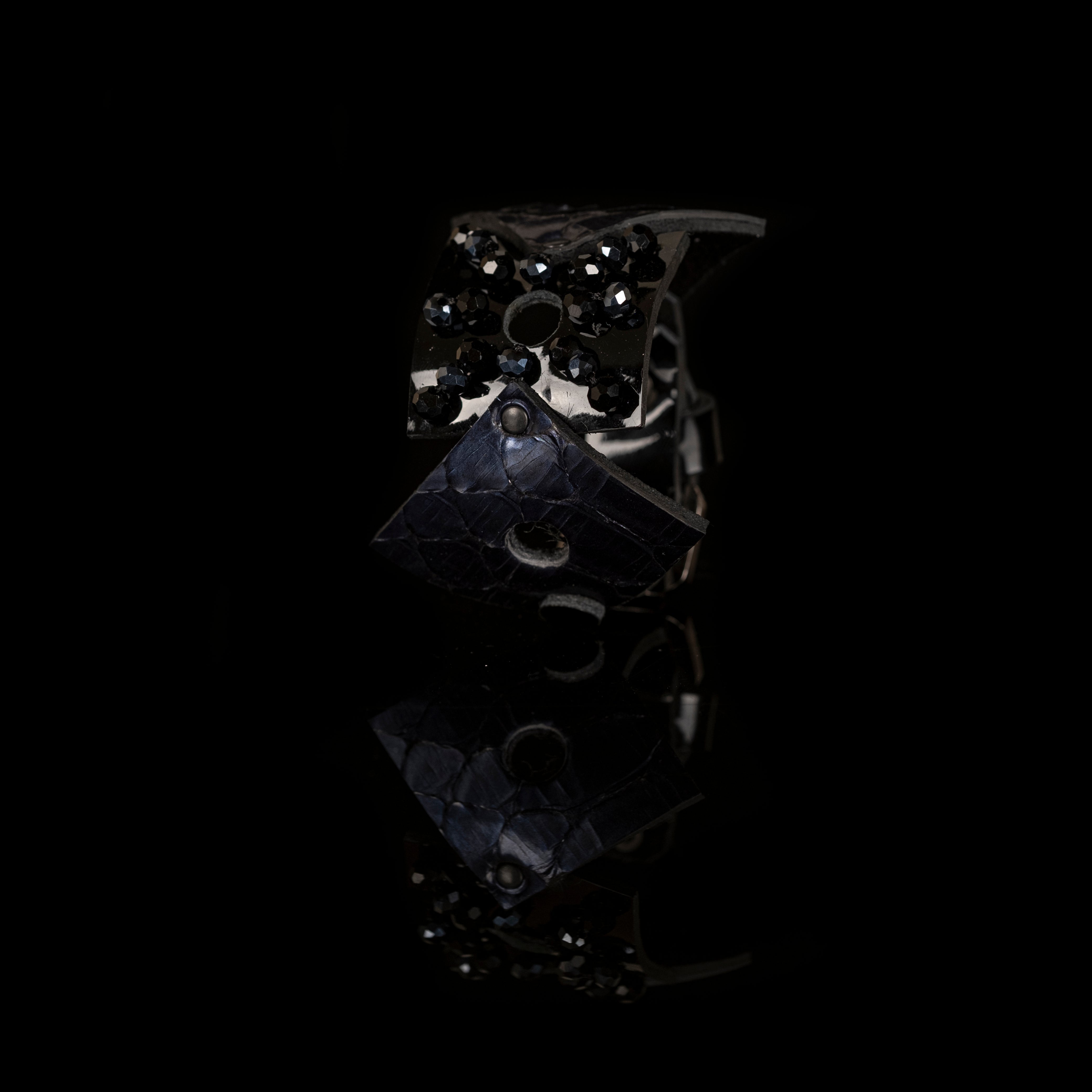 Black sculptural leather bracelet with faceted black crystal bead flower and python leather accents, handmade statement cuff by THE DARK