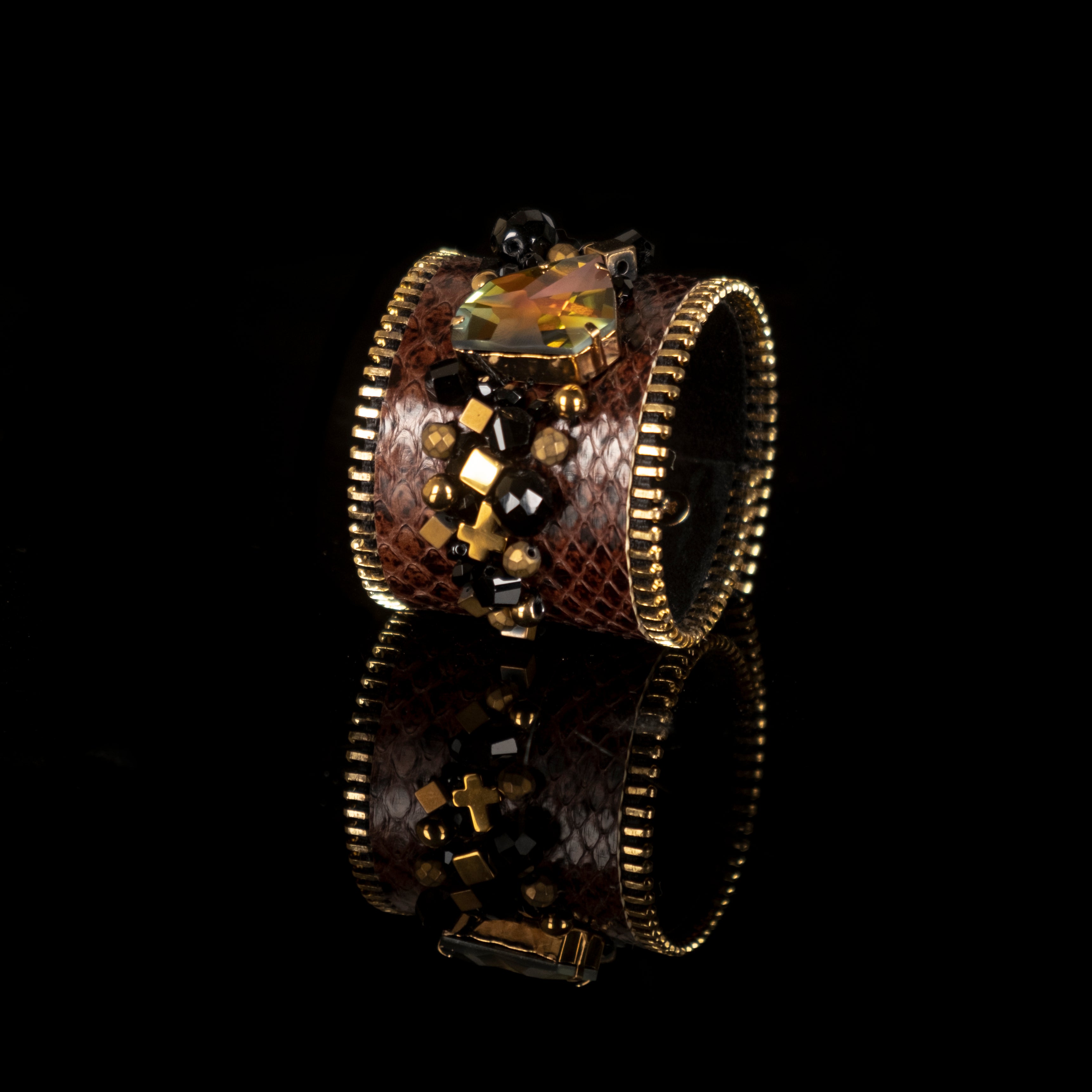 Brown python leather cuff bracelet with amber crystal centerpiece, gold zipper edges and bead embellishment, handmade by THE DARK

