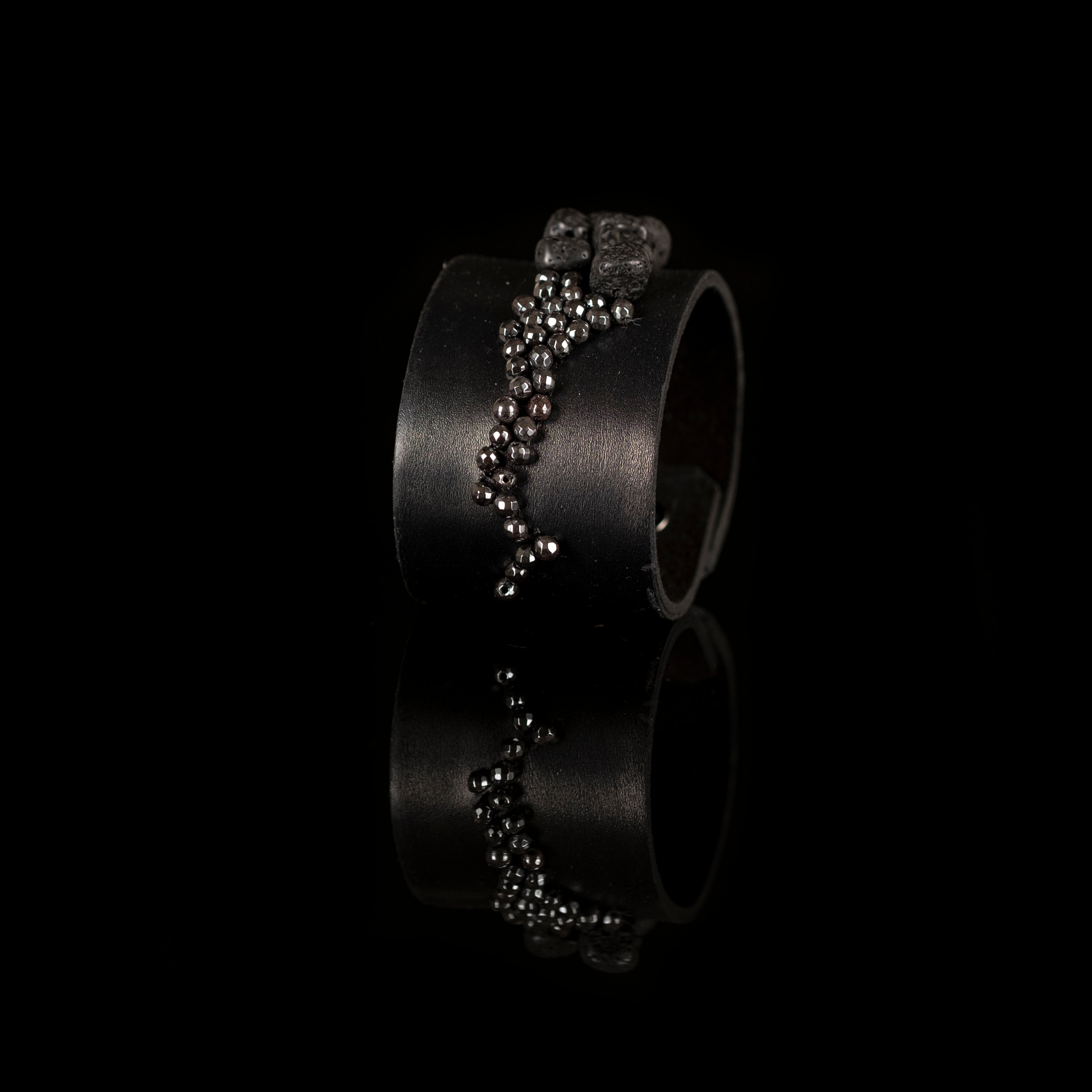 Black leather cuff bracelet with cascading metallic bead and lava stone detail, handmade statement bracelet by THE DARK