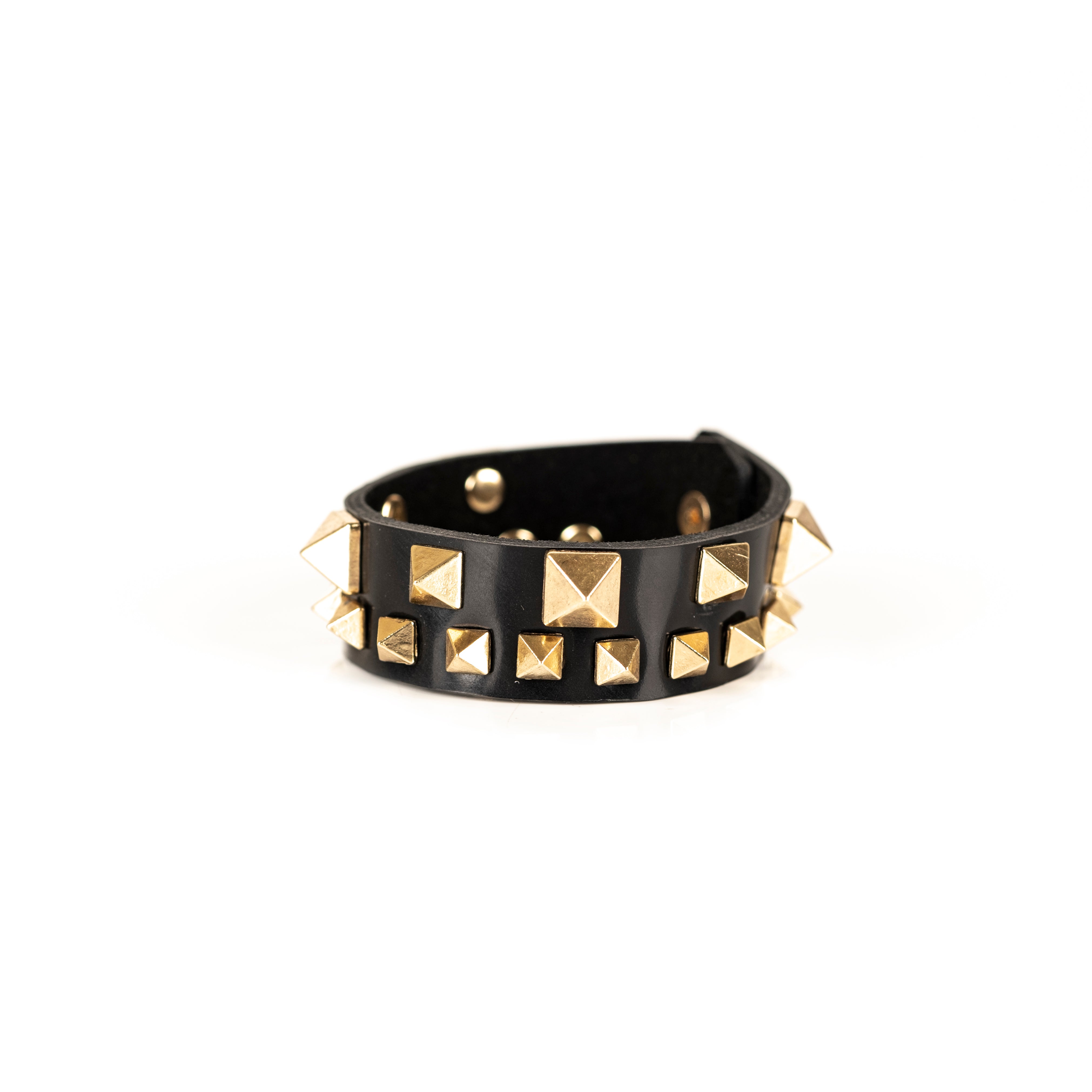 Black leather cuff bracelet with gold pyramid studs and geometric metal details, handmade statement bracelet by THE DARK