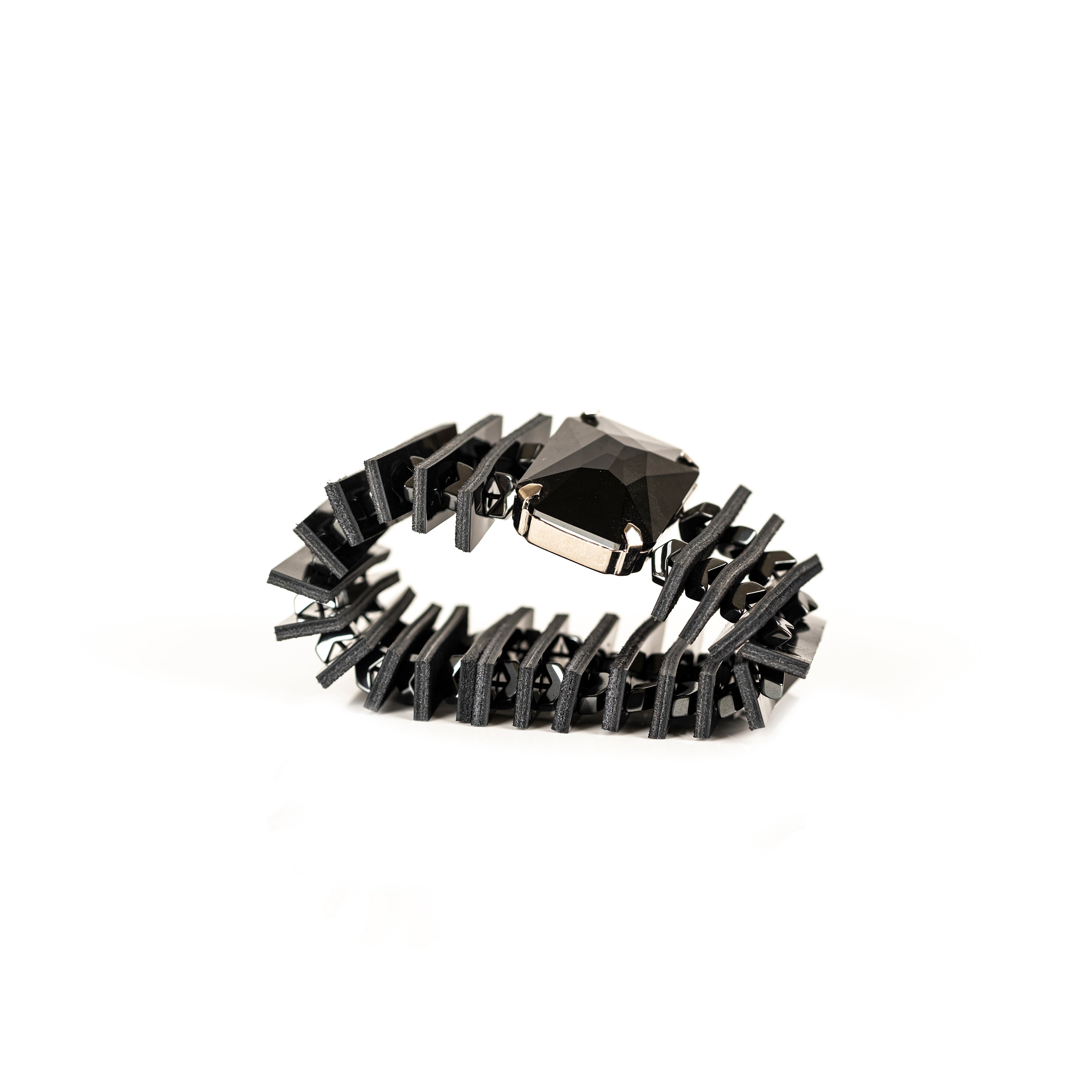 Black leather sculptural bracelet with large faceted black crystal and layered geometric leather panels, handmade statement bracelet by THE DARK