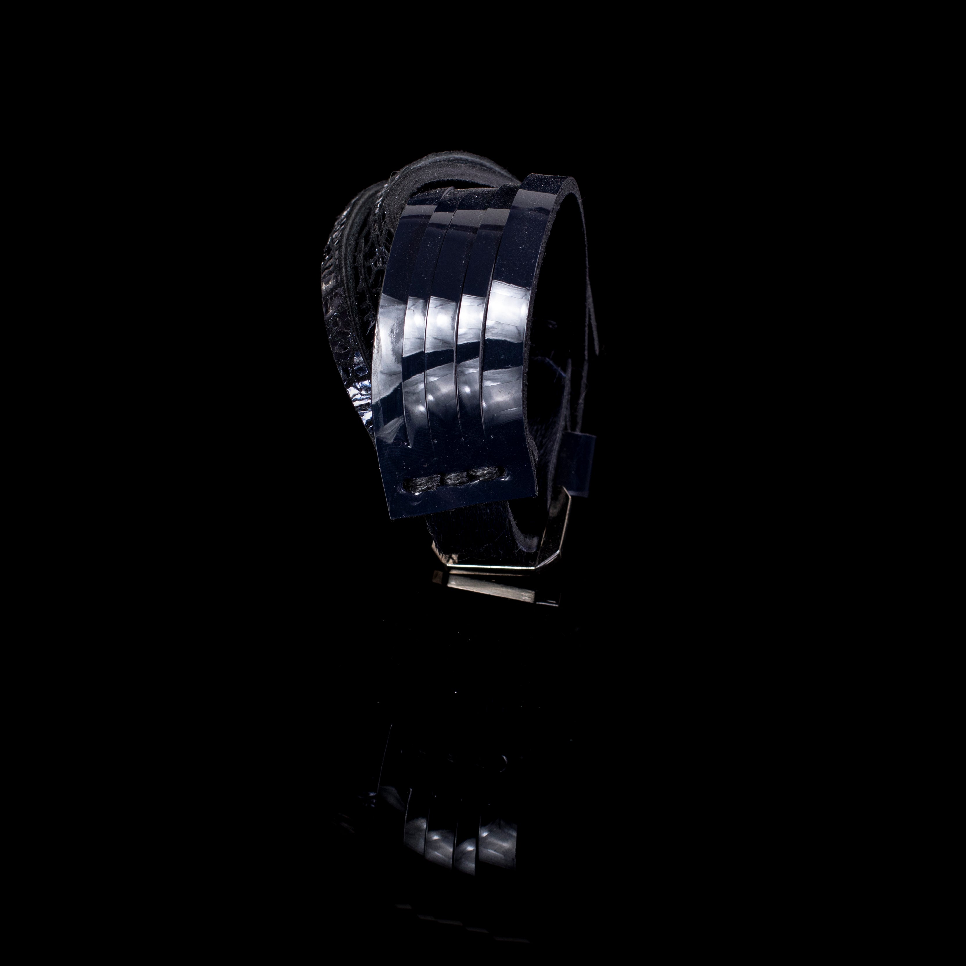 Black patent leather cuff bracelet with glossy linear panel design and layered leather construction, handcrafted wide statement bracelet for women by THE DARK