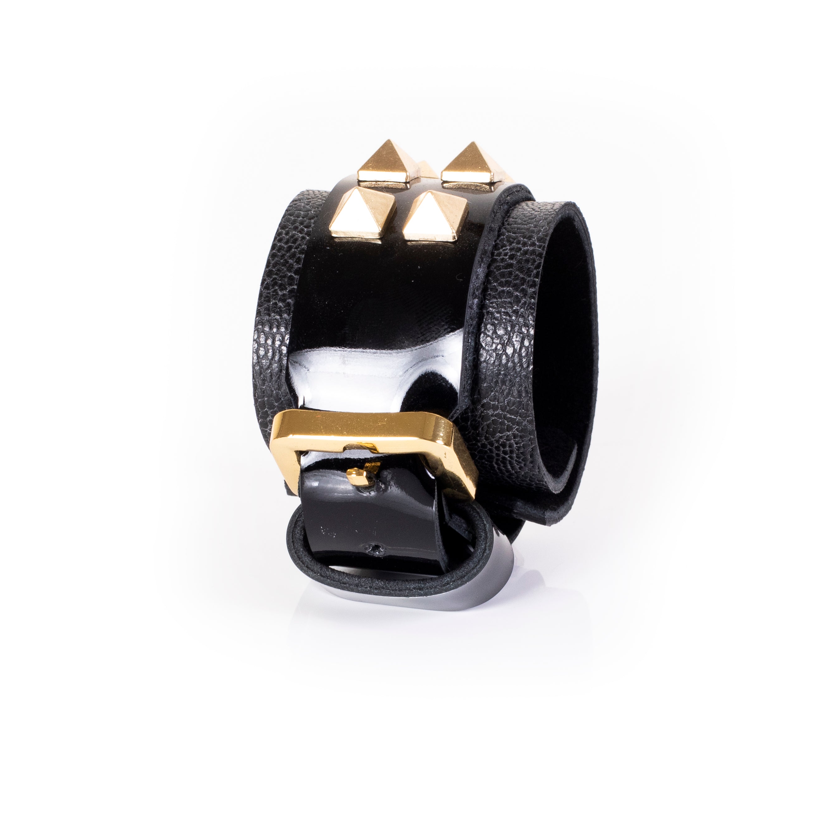 Black patent leather cuff bracelet with gold pyramid studs and textured leather side panels, wide handcrafted statement bracelet for women by THE DARK