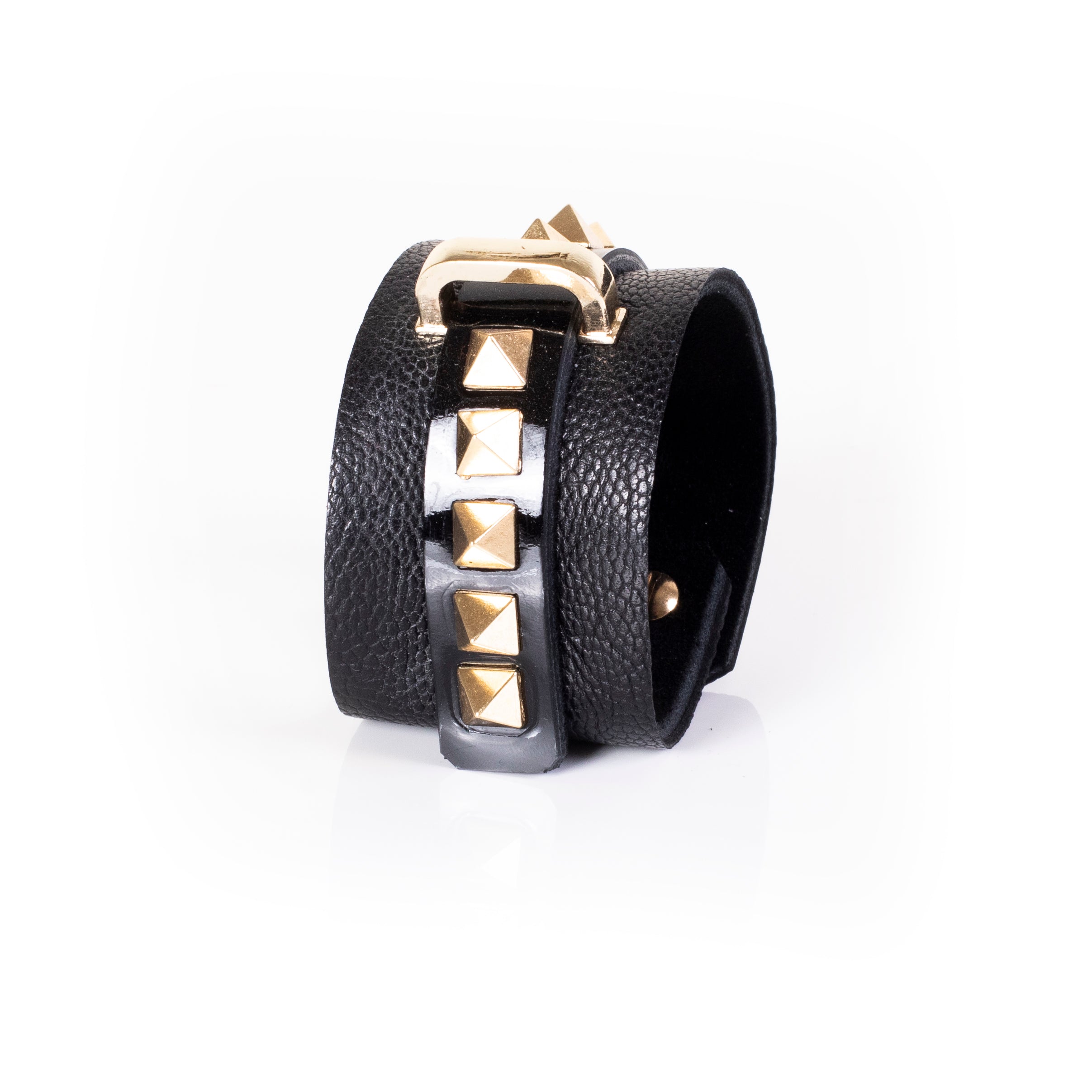 Black leather wrap cuff bracelet with gold pyramid studs, central glossy strip and gold buckle detail, handcrafted statement bracelet for women by THE DARK
