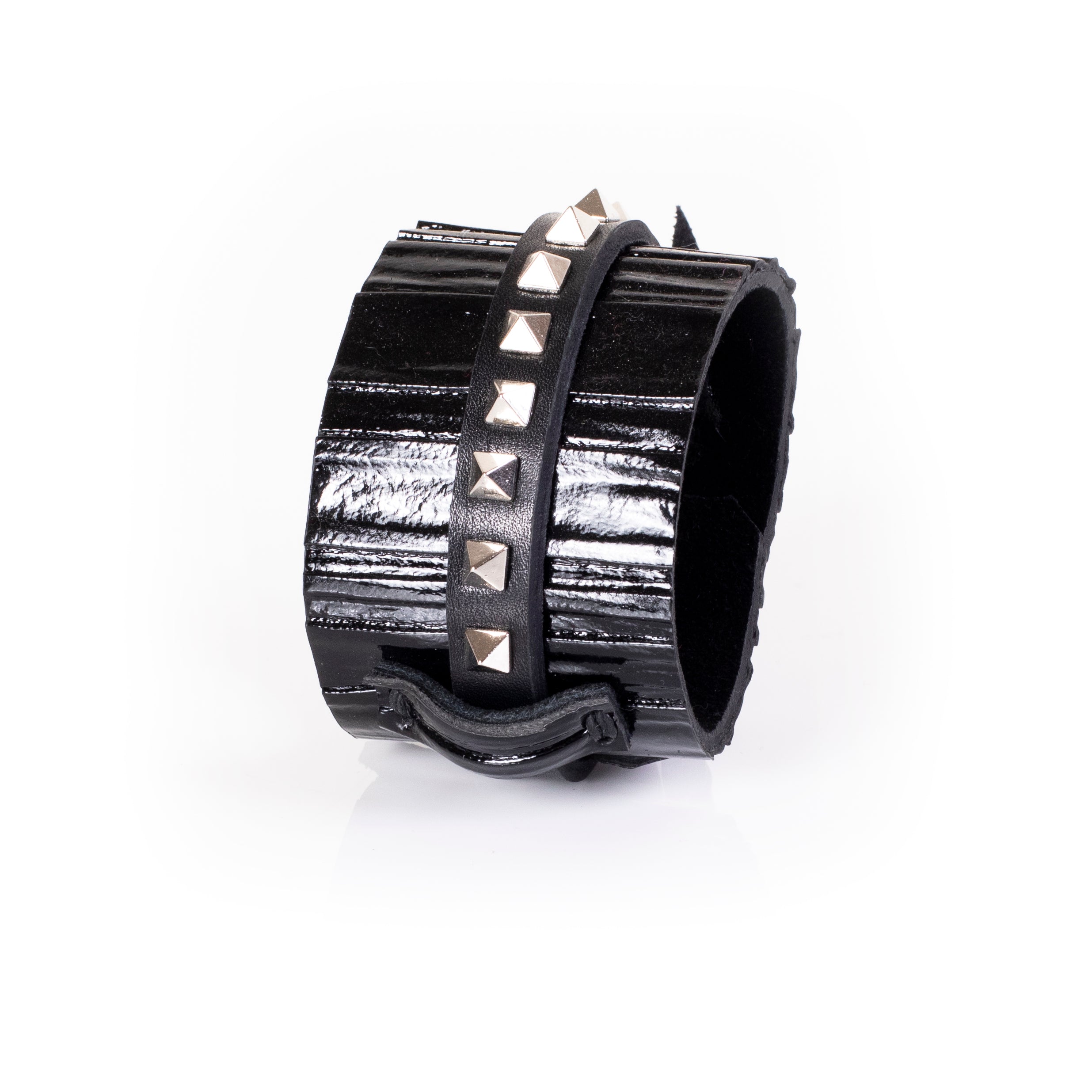 Black patent leather cuff bracelet with central studded leather strap and textured glossy surface, handcrafted wide statement bracelet for women by THE DARK