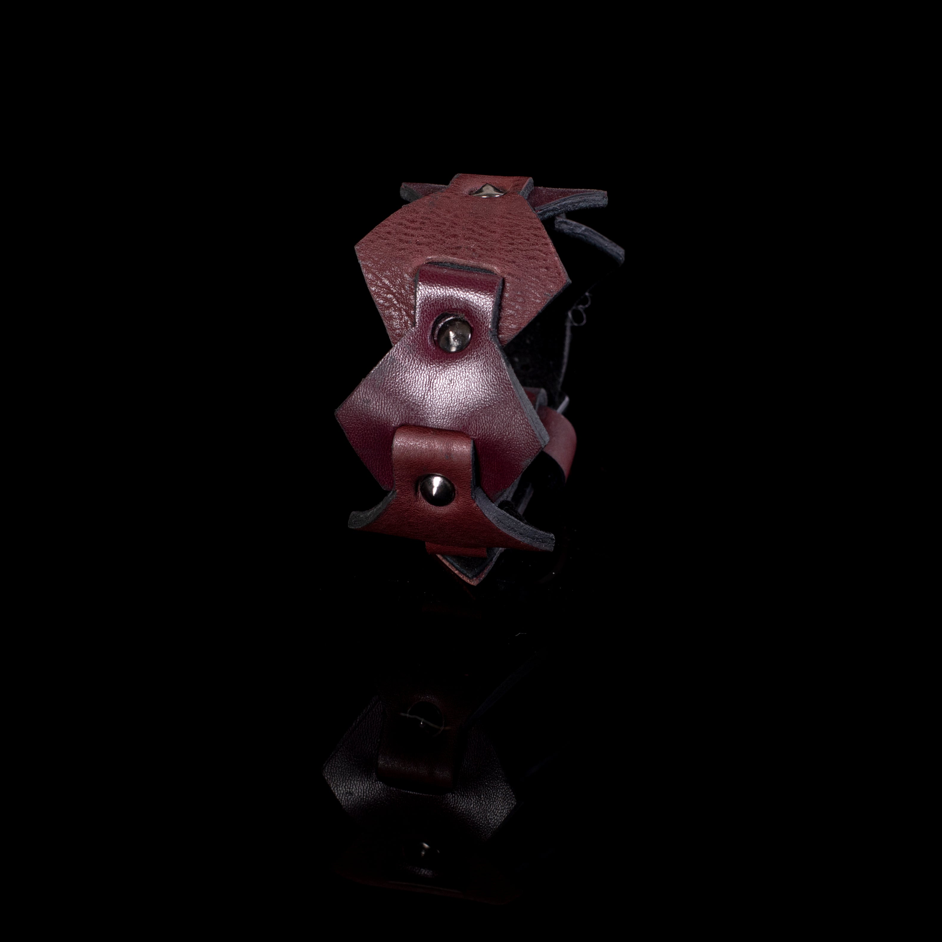 Burgundy leather cuff bracelet with layered geometric panels and metal studs, handcrafted wide statement bracelet for women