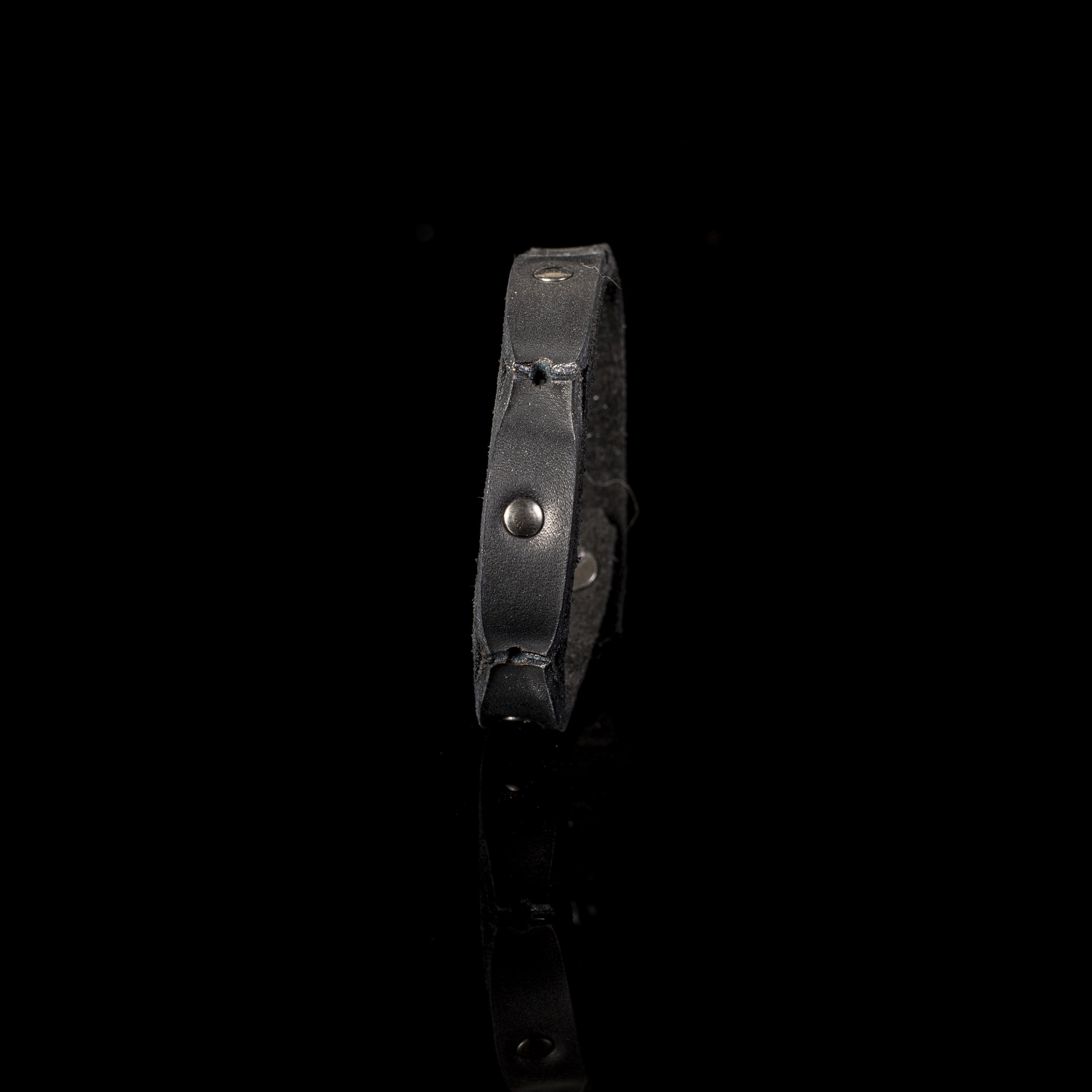 Handmade slim black leather bracelet featuring matte gunmetal studs and a secure snap closure.