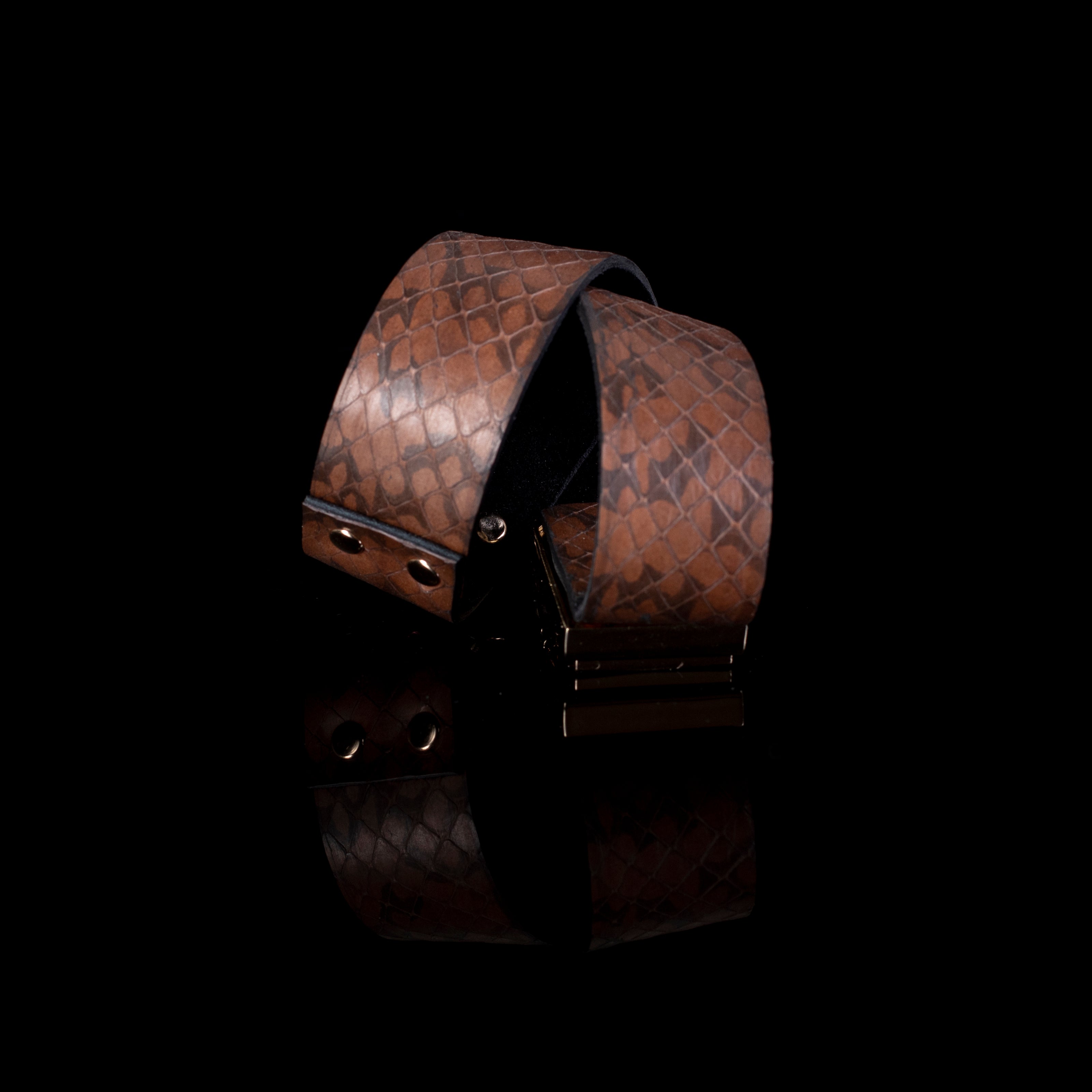 Brown textured leather cuff bracelet with wrap design and gold clasp, wide sculptural statement bracelet for women