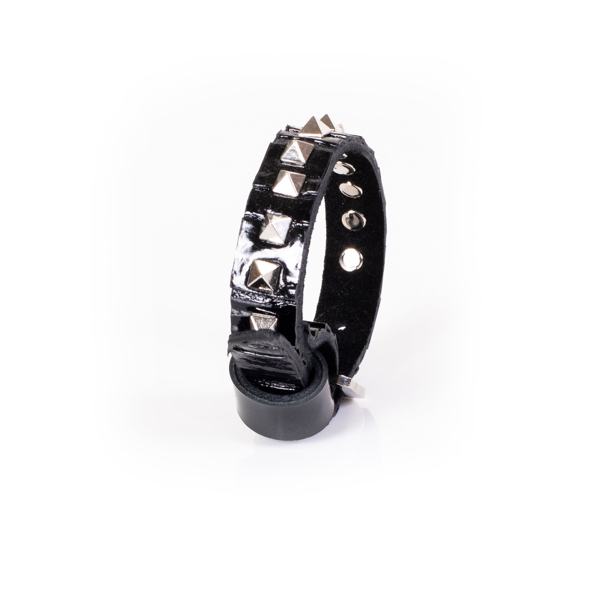 Black patent leather slim cuff bracelet with silver pyramid studs in vertical alignment, handcrafted statement bracelet for women by THE DARK