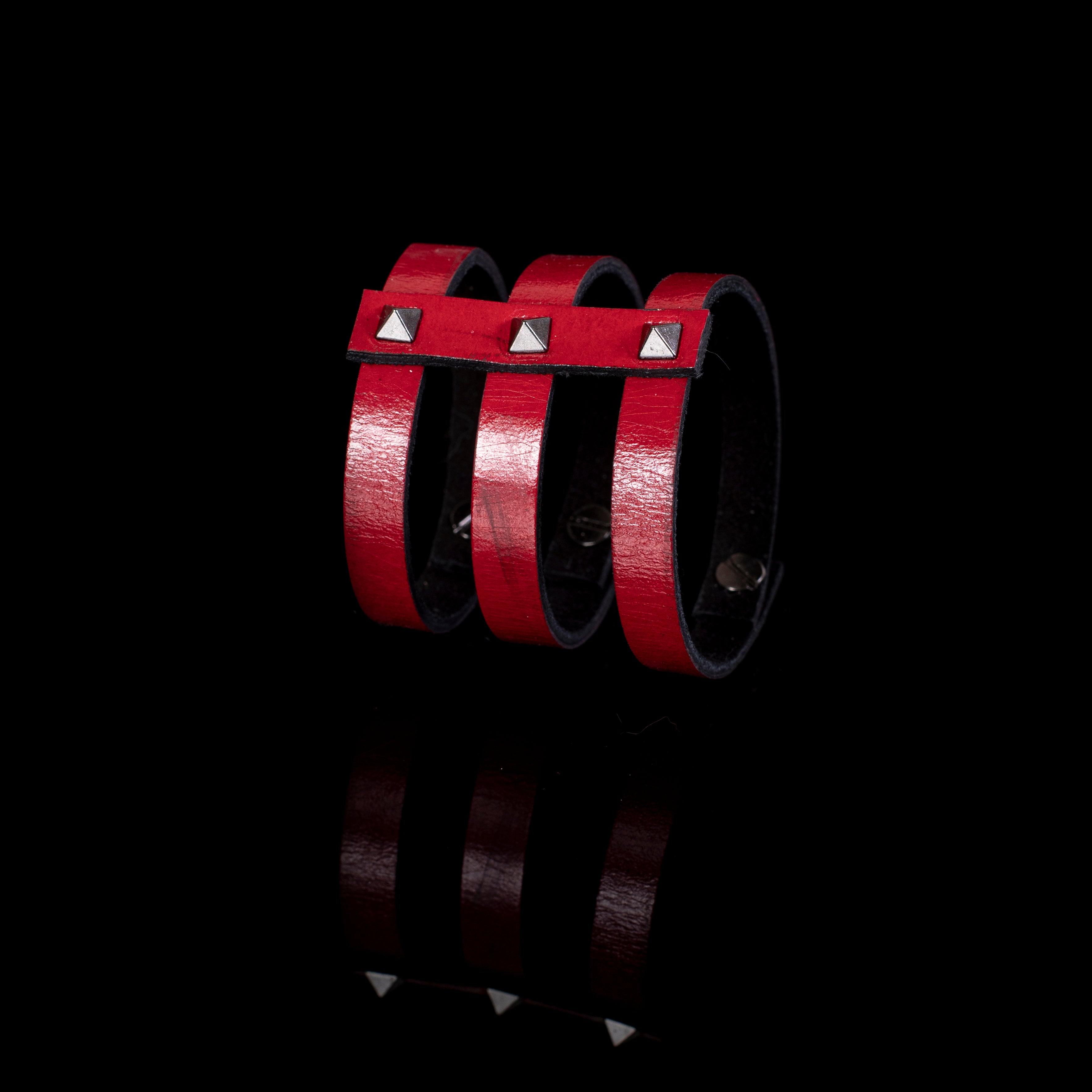 Red leather triple strap cuff bracelet with silver pyramid studs and black interior lining, handcrafted structured bracelet for women by THE DARK