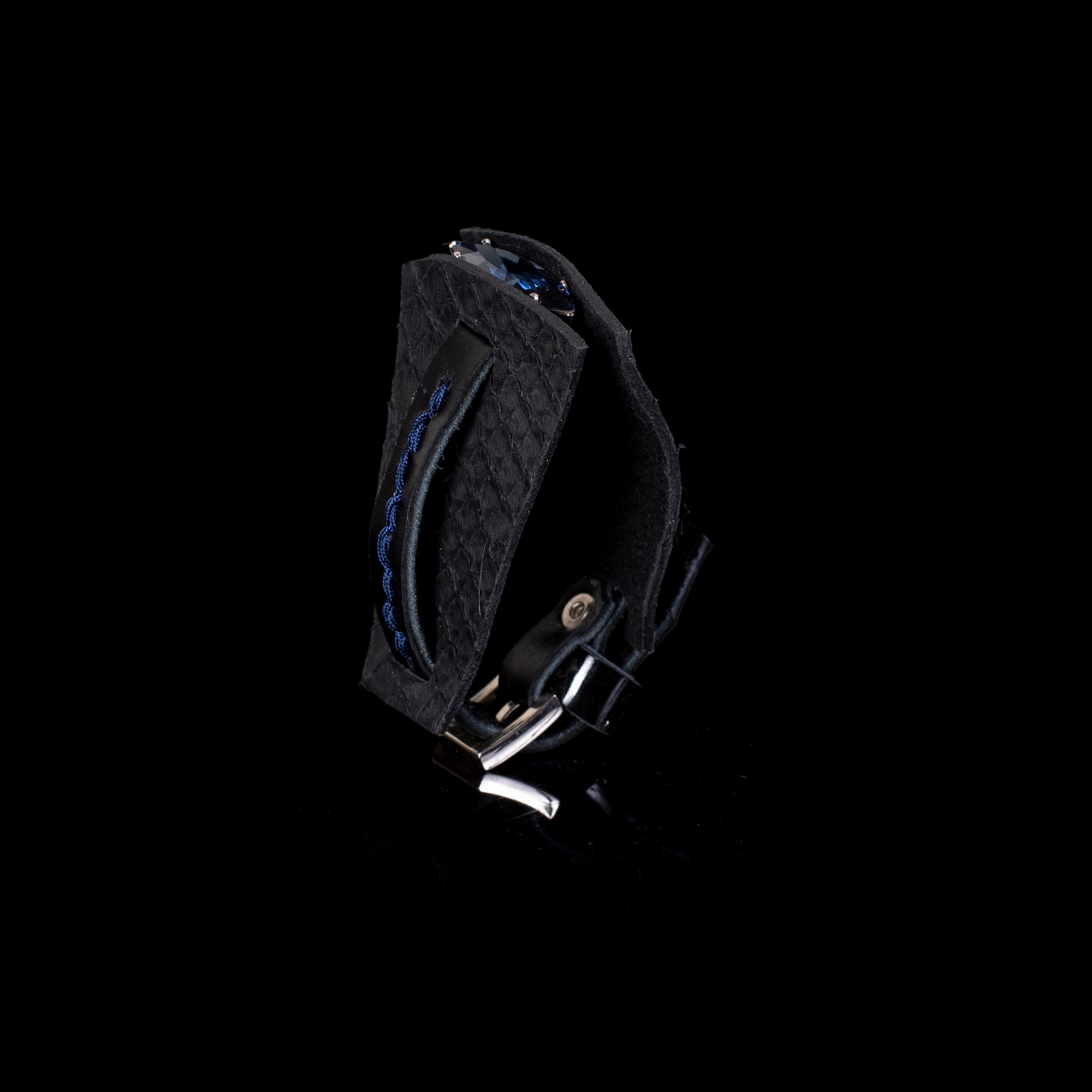 Black textured leather cuff bracelet with sculptural layered design, blue braided detail and crystal accent, handcrafted statement bracelet for women by THE DARK