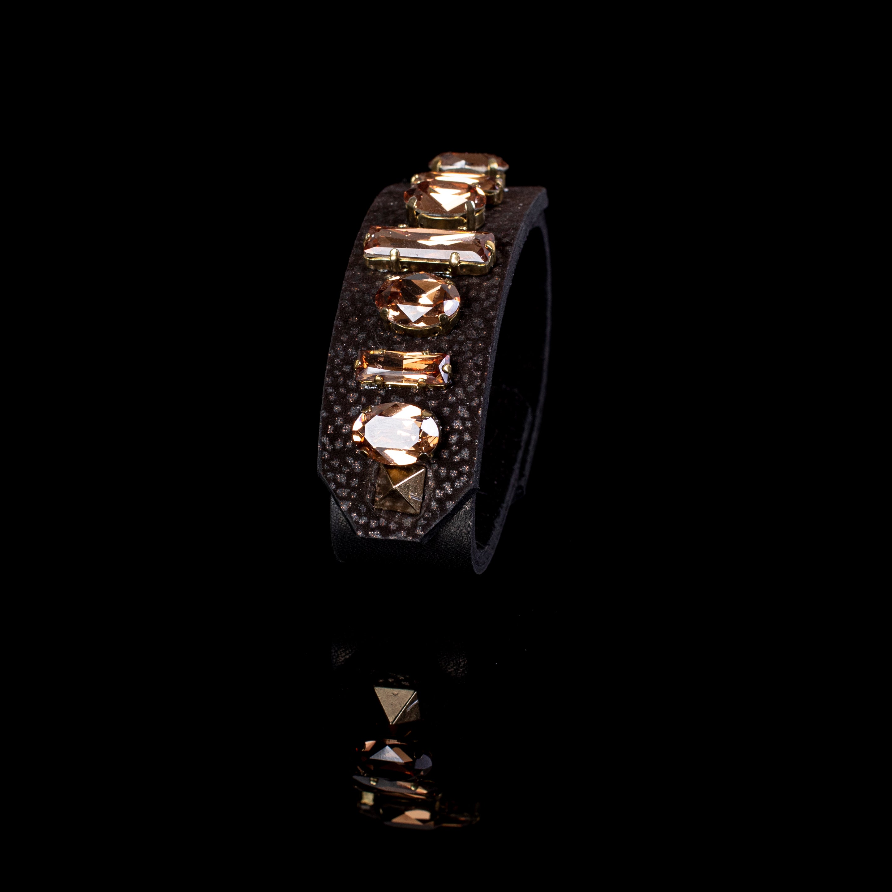 Black textured leather cuff bracelet with champagne crystal stones and gold bar detail, wide handcrafted statement bracelet for women
