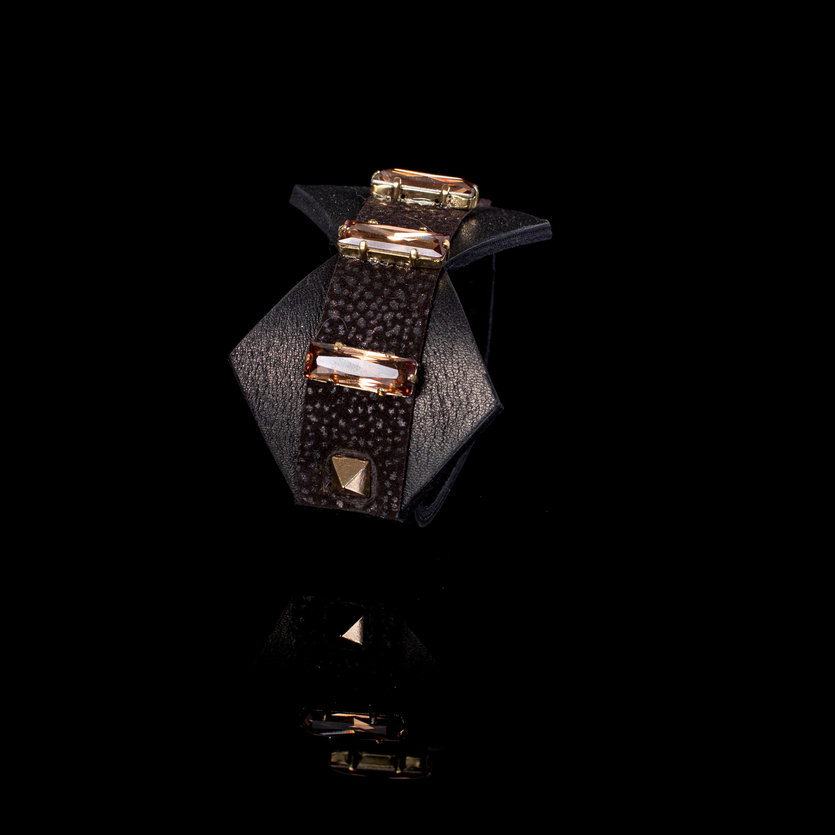 Black textured leather cuff bracelet with champagne rectangular crystals and gold stud detail, wide handcrafted statement bracelet for women